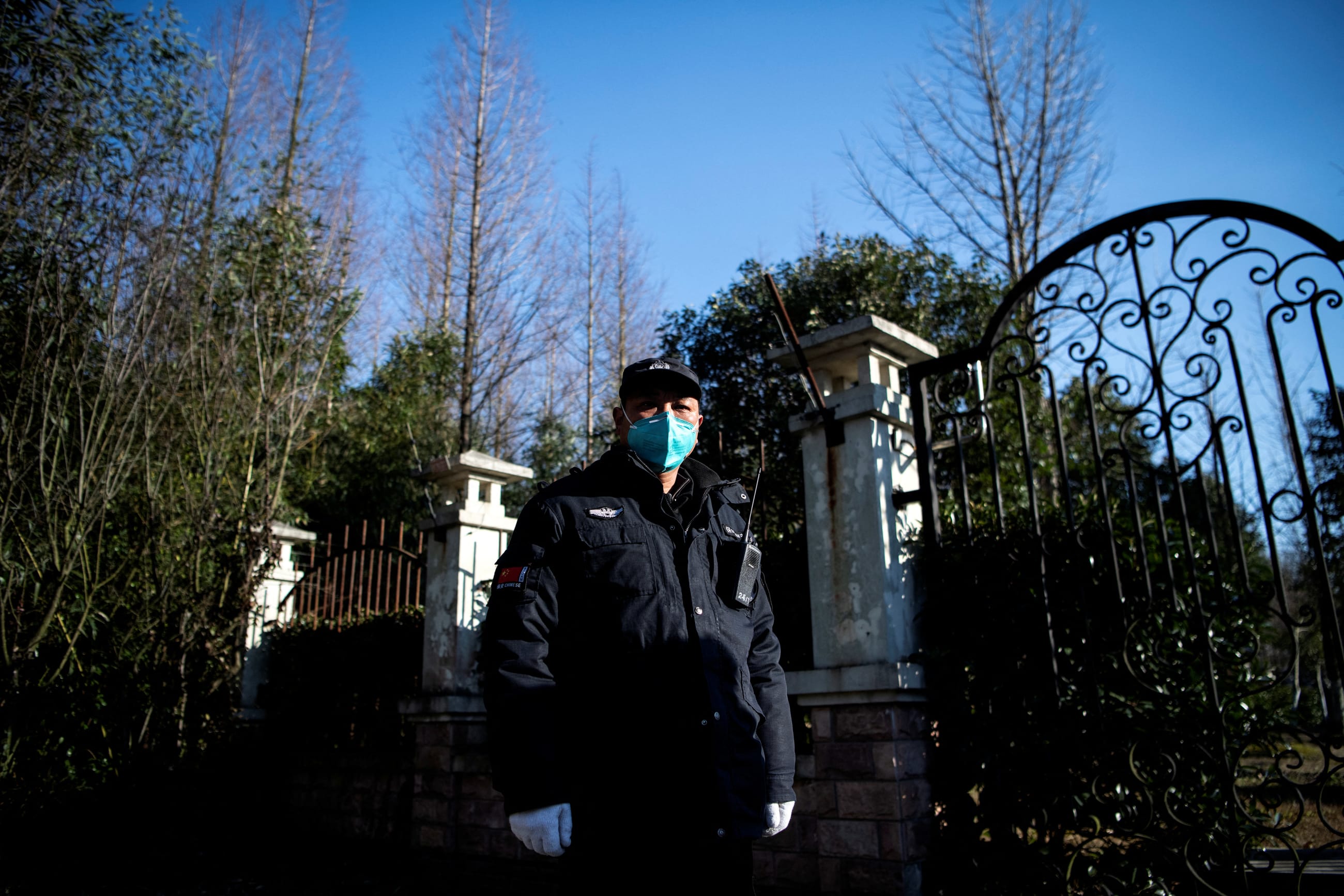 A guard stands at the gate of the Shanghai Public Health Clinical Center in China, February 17, 2020.