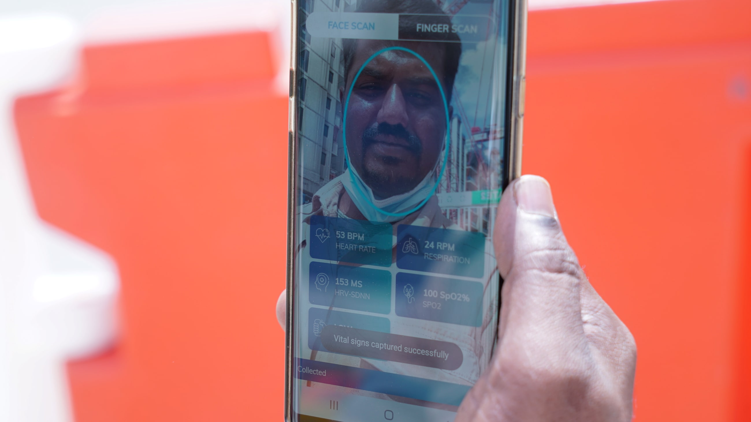 Gunasekar Udayakumar uses the Nervotec app to scan his face and check his vital signs as part of a daily checkup for employees, at a construction site in central Singapore, on February 19 2021.,