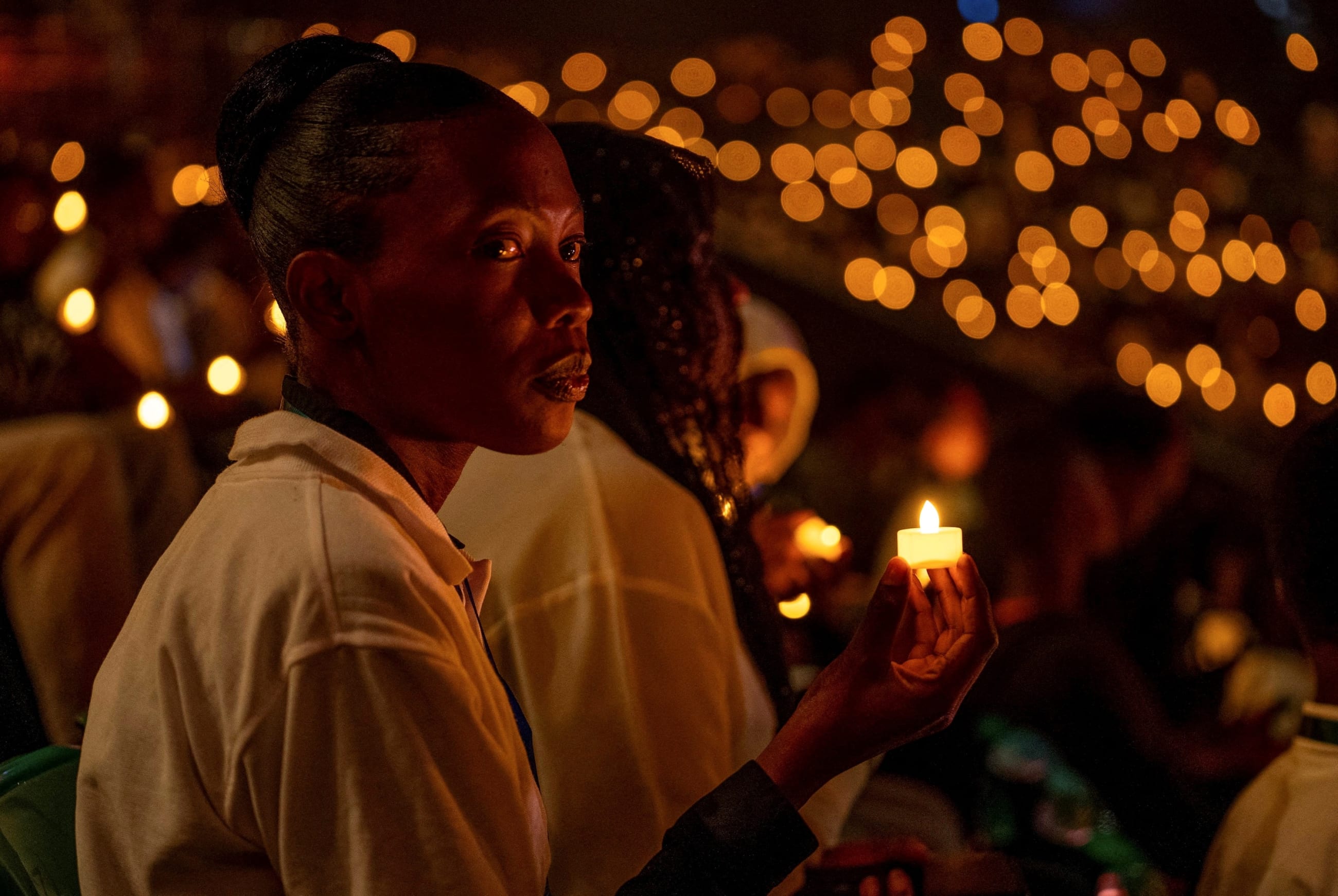 Participants hold a candlelight night vigil during a commemoration event, as Rwanda marks the 30th anniversary of the 1994 Genocide, in Kigali, Rwanda, on April 7, 2024.