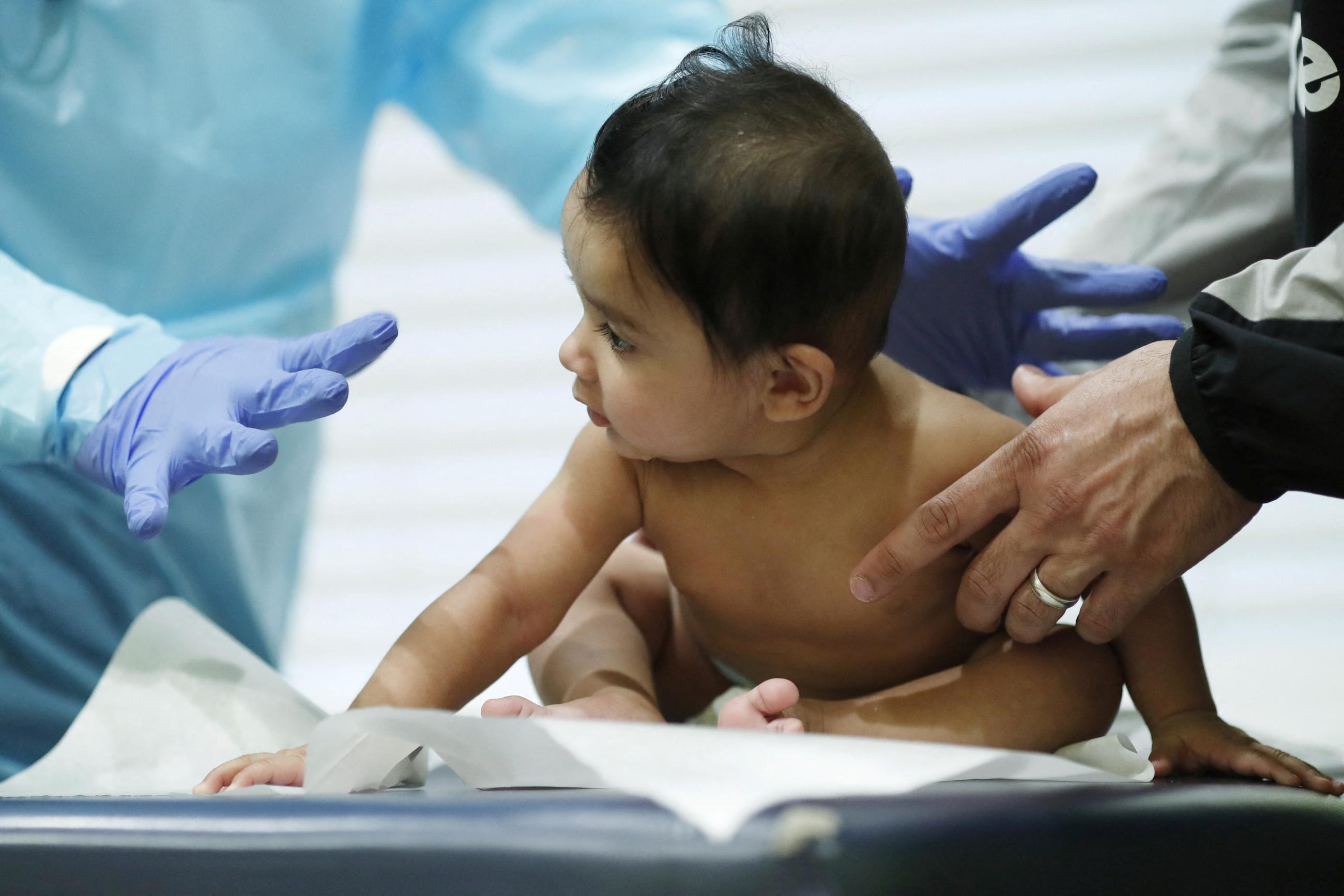 Greg Gulbransen, MD, &nbsp;performs a routine checkup on a&nbsp;baby&nbsp;at his pediatric practice.