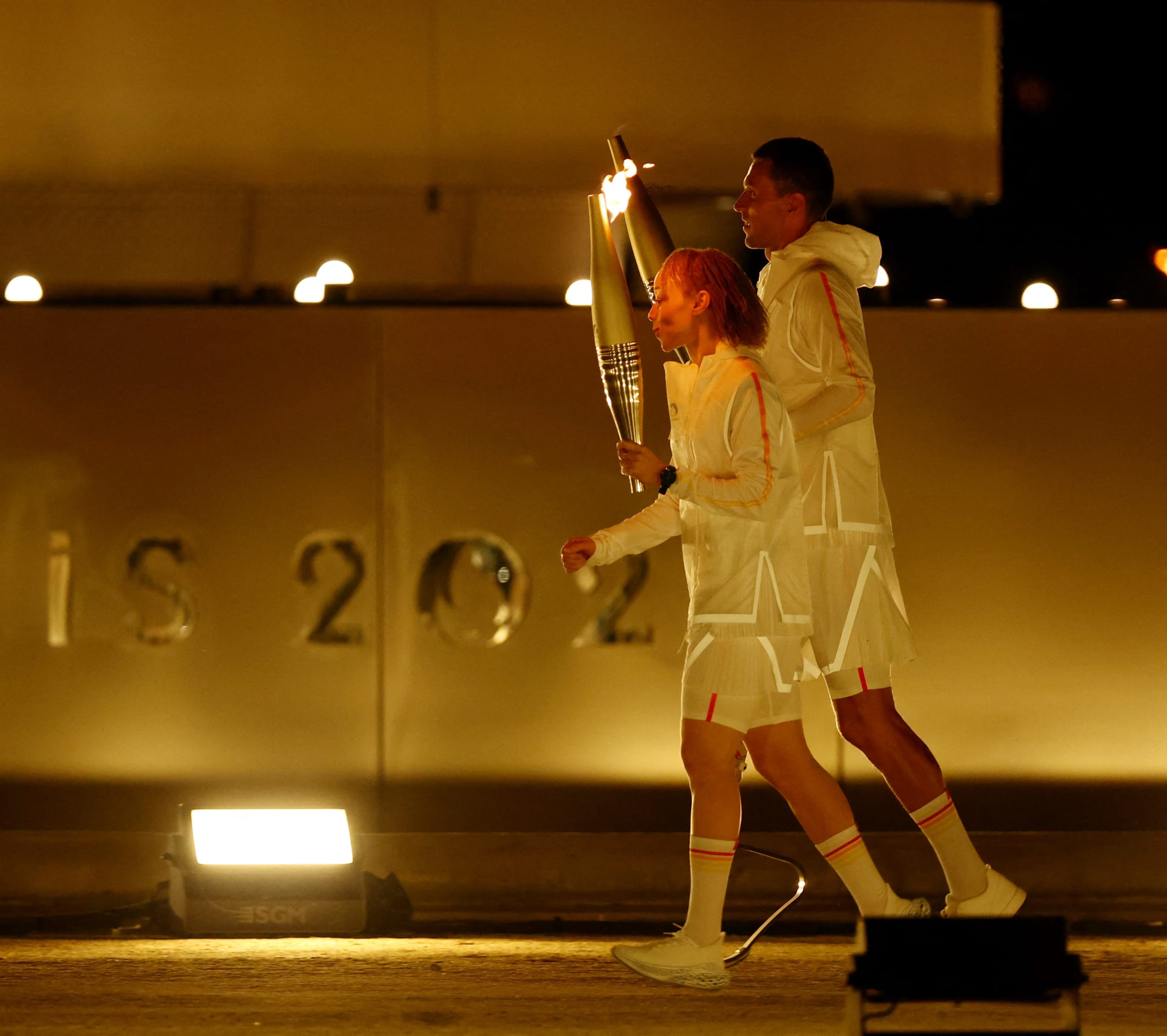 Alexis Hanquinquant of France and Nantenin Keita of France  prepare to light the cauldron during the opening ceremony of the Paris 2024 Paralympics