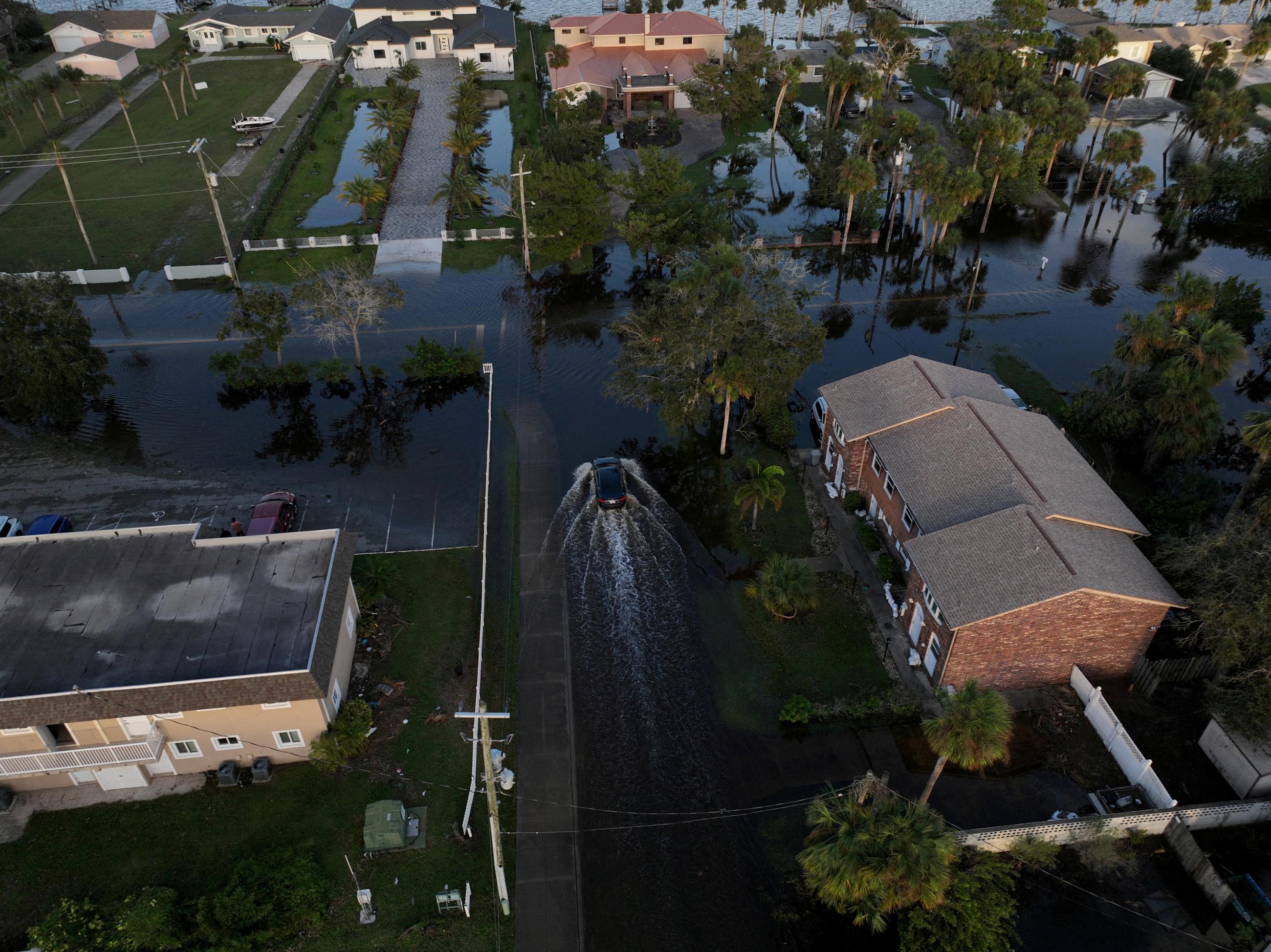 A drone view shows a car driving through a flooded street after&nbsp;Hurricane&nbsp;Milton&nbsp;made landfall.