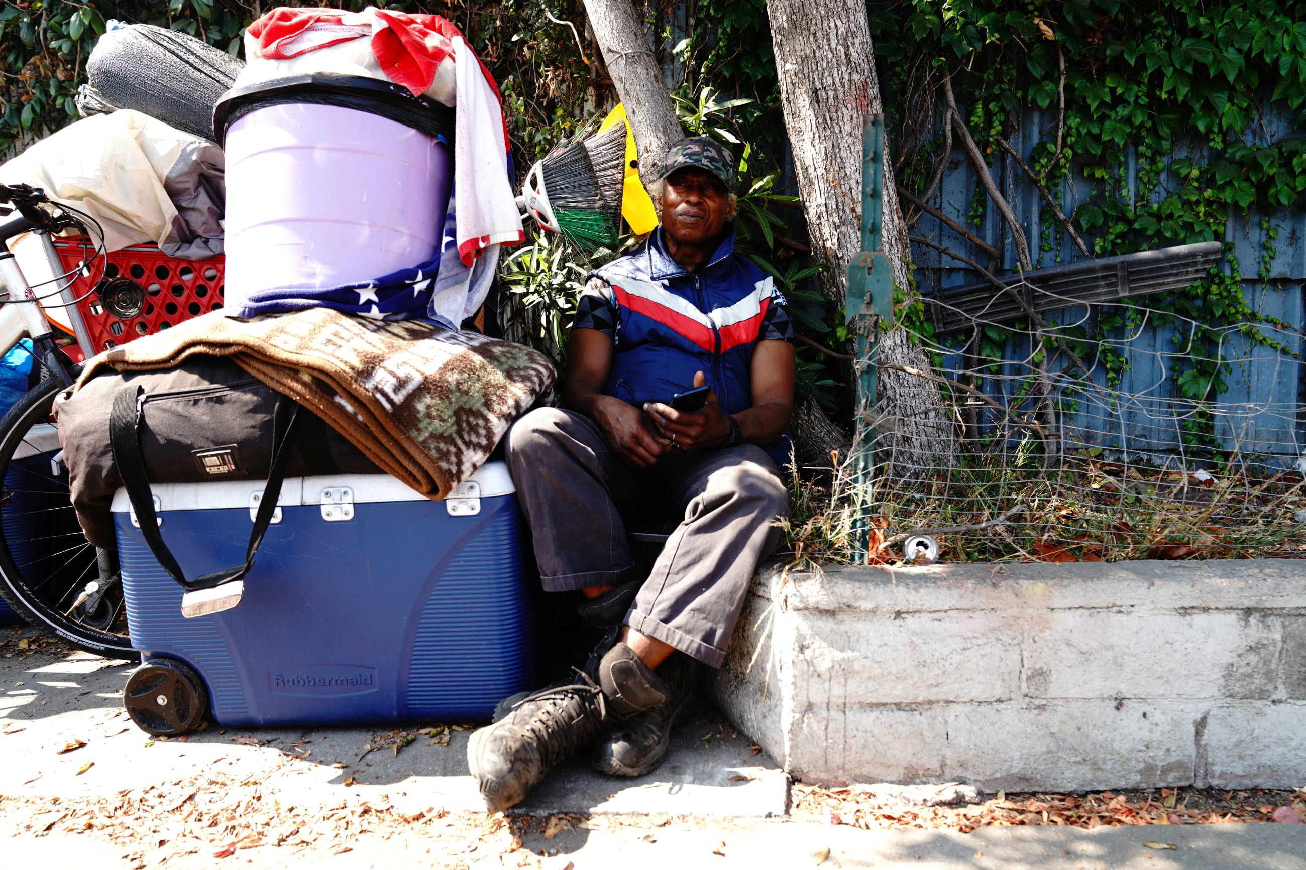 Halo, an unhoused person, poses for a portrait after being displaced by police and sanitation workers clearing unhoused people from a homeless encampment in Harbor City, Los Angeles, California, U.S., July 1, 2021. 
