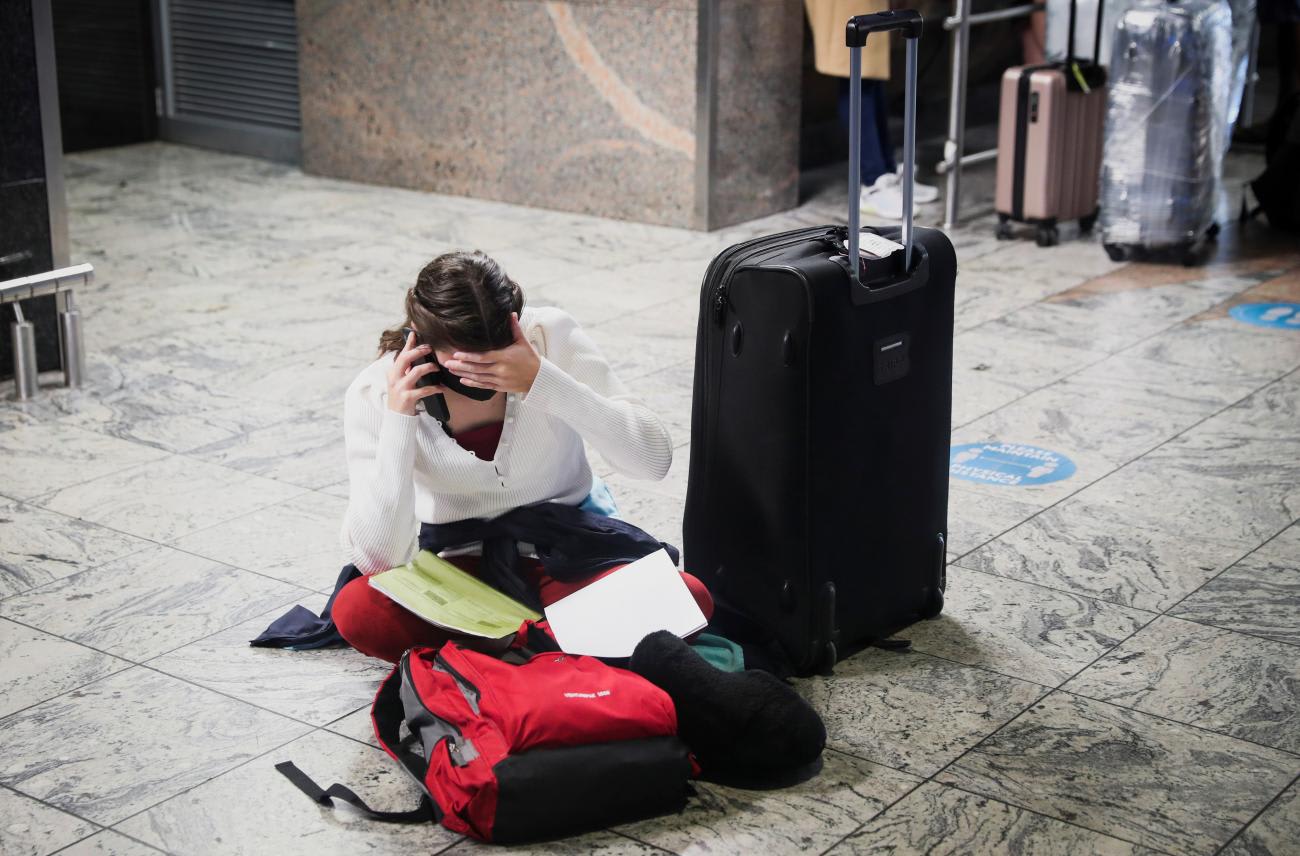 A passenger tries to find a flight as several airlines have stopped flying out of&nbsp;South&nbsp;Africa, due to the spread of the COVID-19 variant&nbsp;Omicron, in Johannesburg,&nbsp;South&nbsp;Africa, on November 28, 2021.