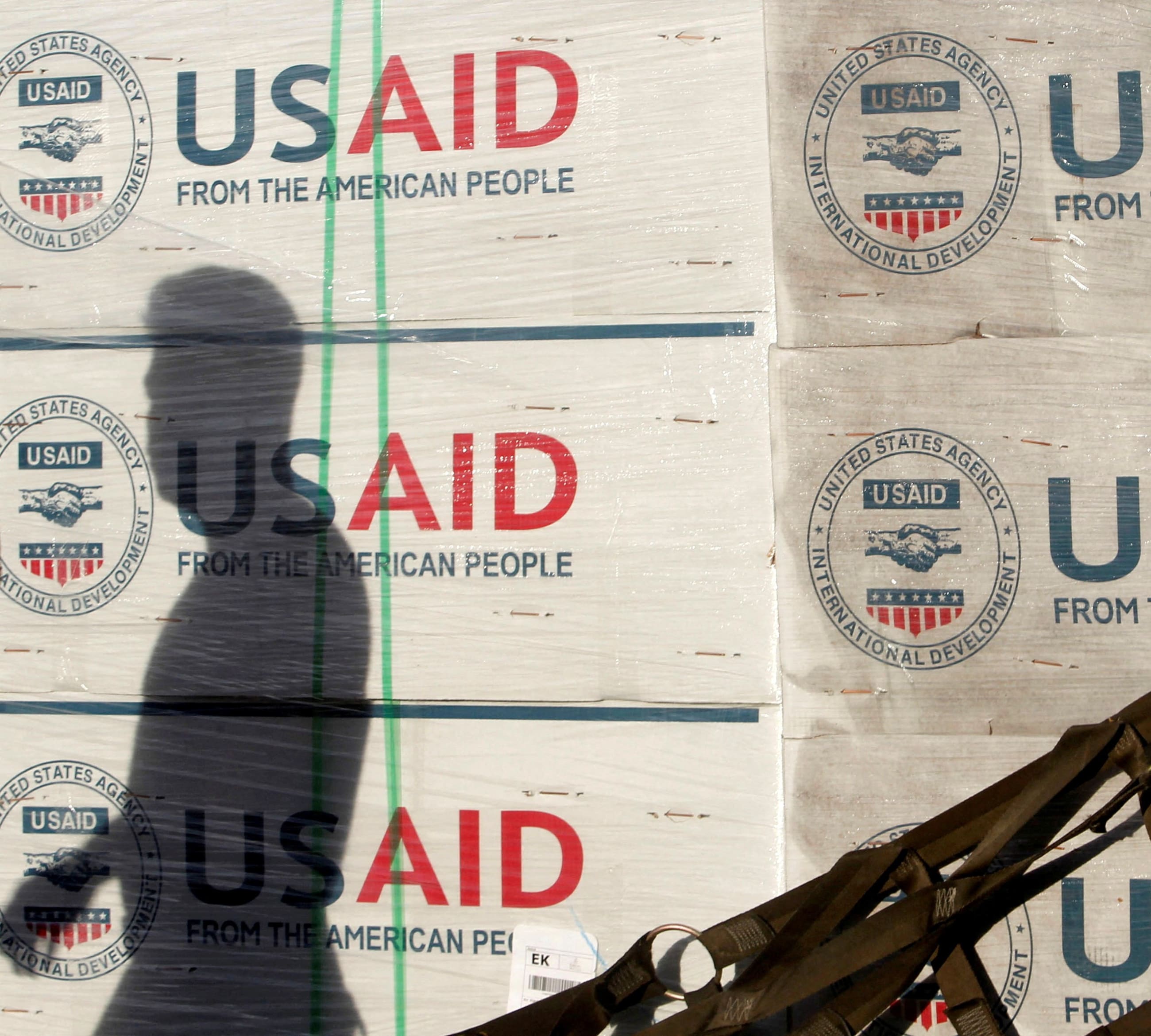 The shadow of a Philippine Army personnel is cast on boxes of relief items from USAID for the victims of super typhoon Haiyan, at Villamor Air Base, in Manila, Philippines, on November 13, 2013. 