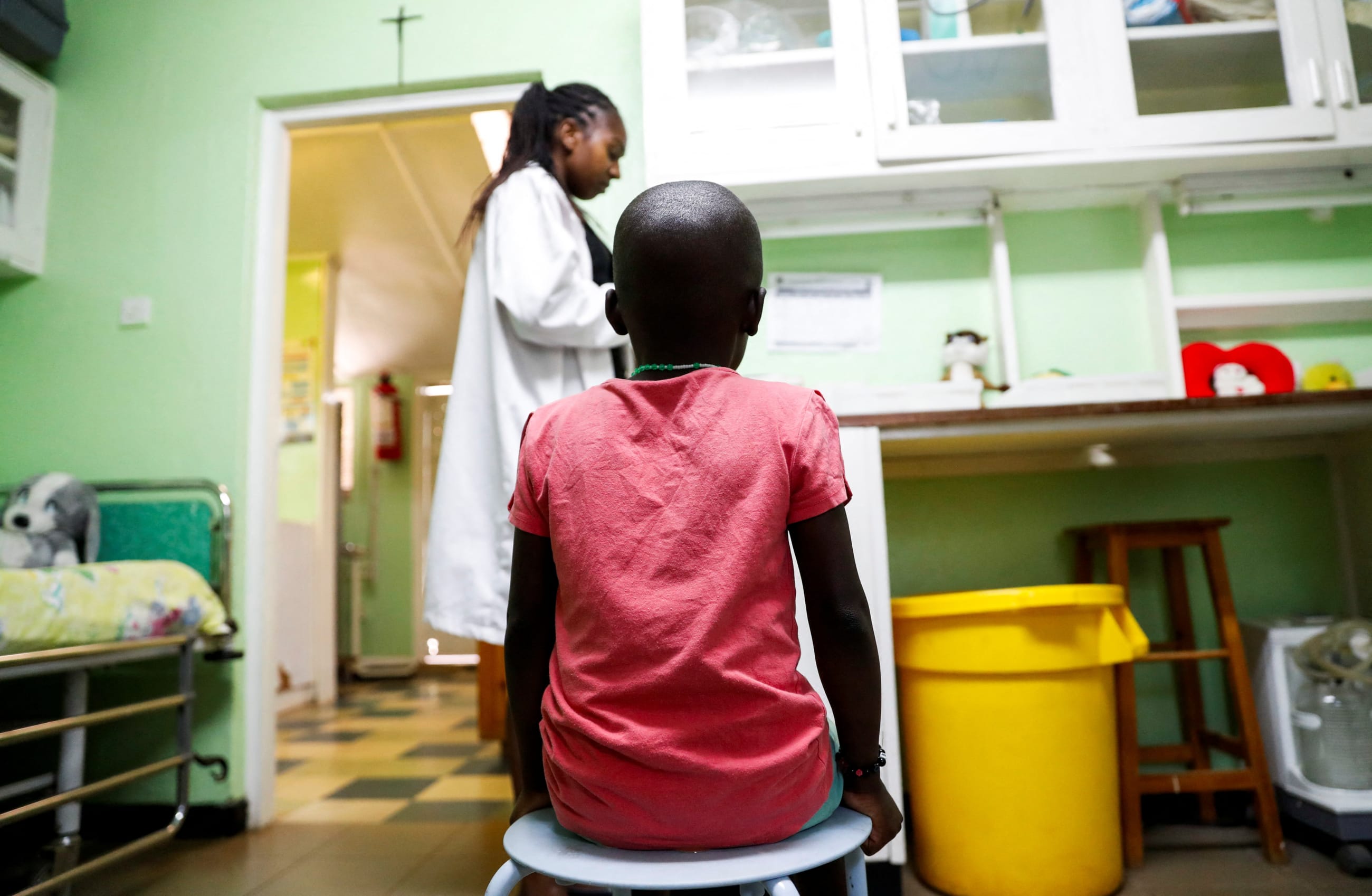 A child sits as a nurse prepares to dispense antiretroviral drugs used to prevent HIV from replicating, at the Nyumbani Children's Home, Nairobi, Kenya, on February 12, 2025.