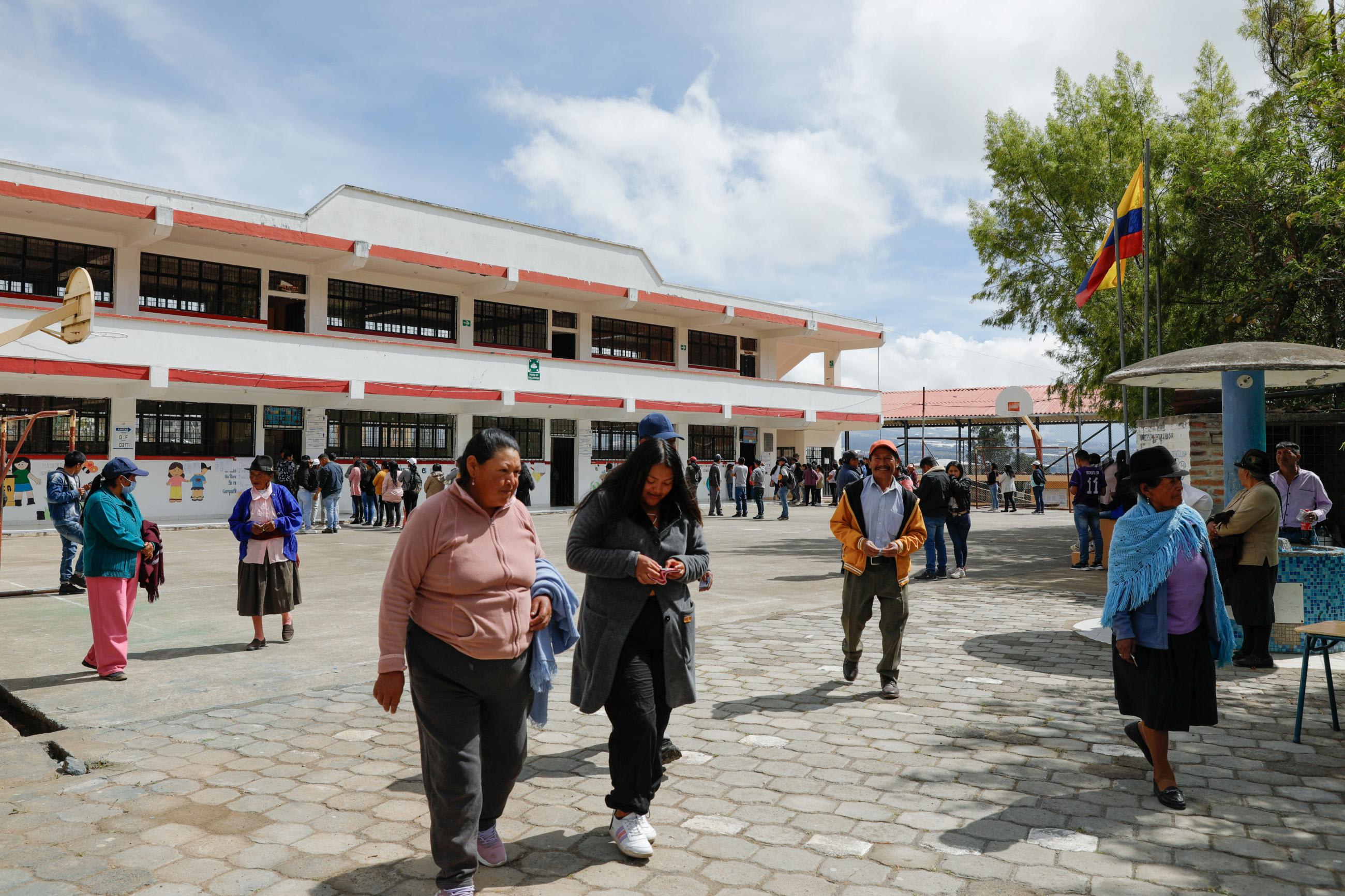 People leave after casting their votes at the Cesar Arroyo&nbsp;school during the presidential elections, in Cayambe, Ecuador, on August 20, 2023. 