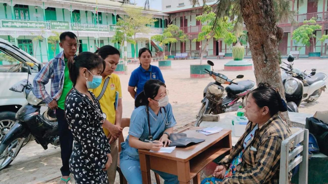 a health worker provides free care to a patient on the streets of Mandalay, Myanmar, following an 7.7 magnitude earthquake that struck on March 28, 2025.