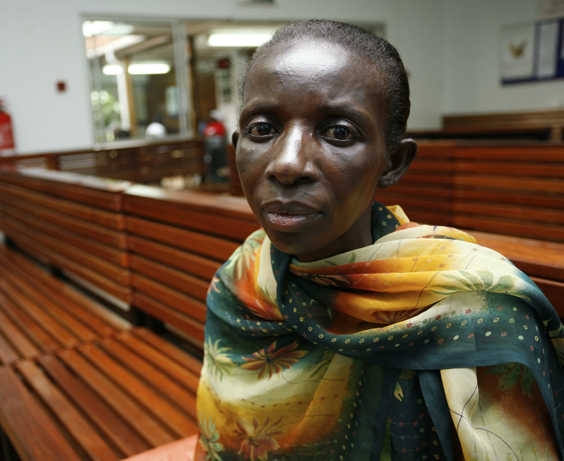 A Ugandan woman living with HIV/AIDS waits to receive antiretroviral drugs from the Infectious Disease Institute, in Kampala, Uganda, on November 30, 2006. 