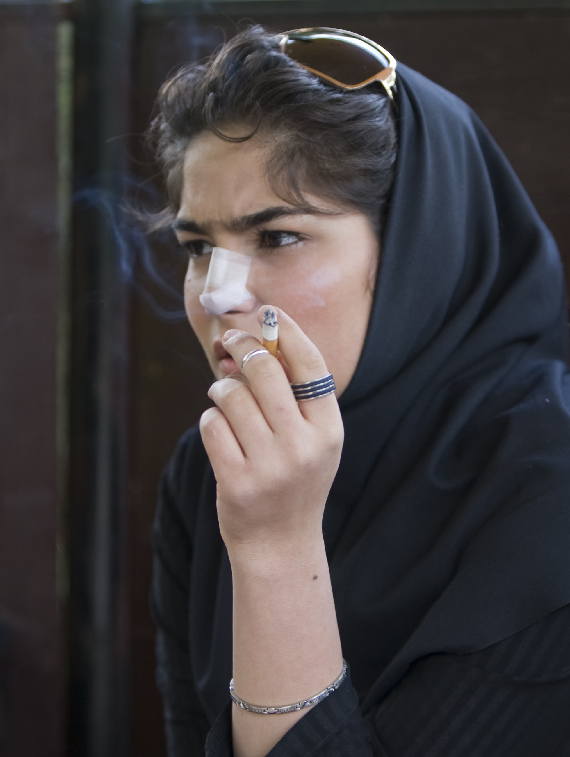A woman smokes as she rests at a park, in central Tehran, Iran, on April 9, 2009.