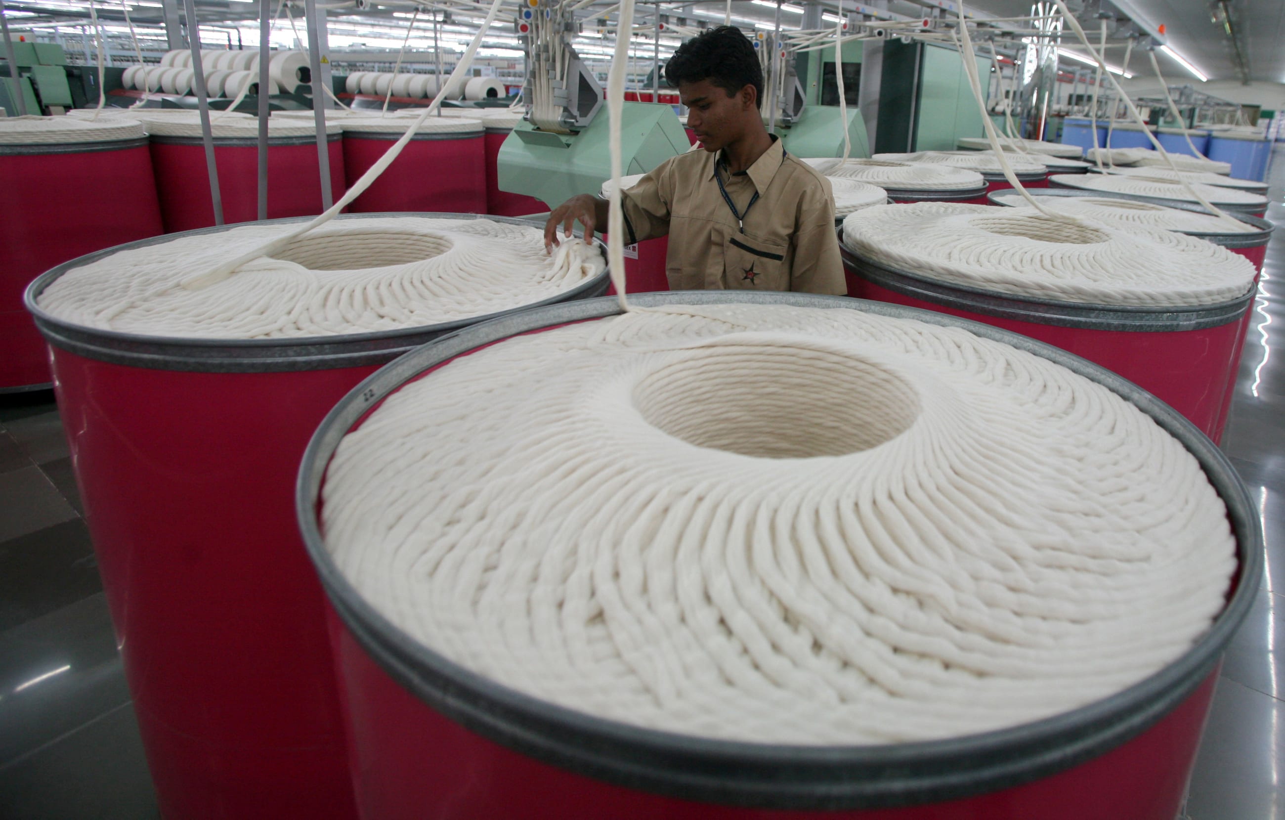 An employee works inside the Century Textiles and Industries Ltd textile mill in Gujarat, India, on October 22, 2009.