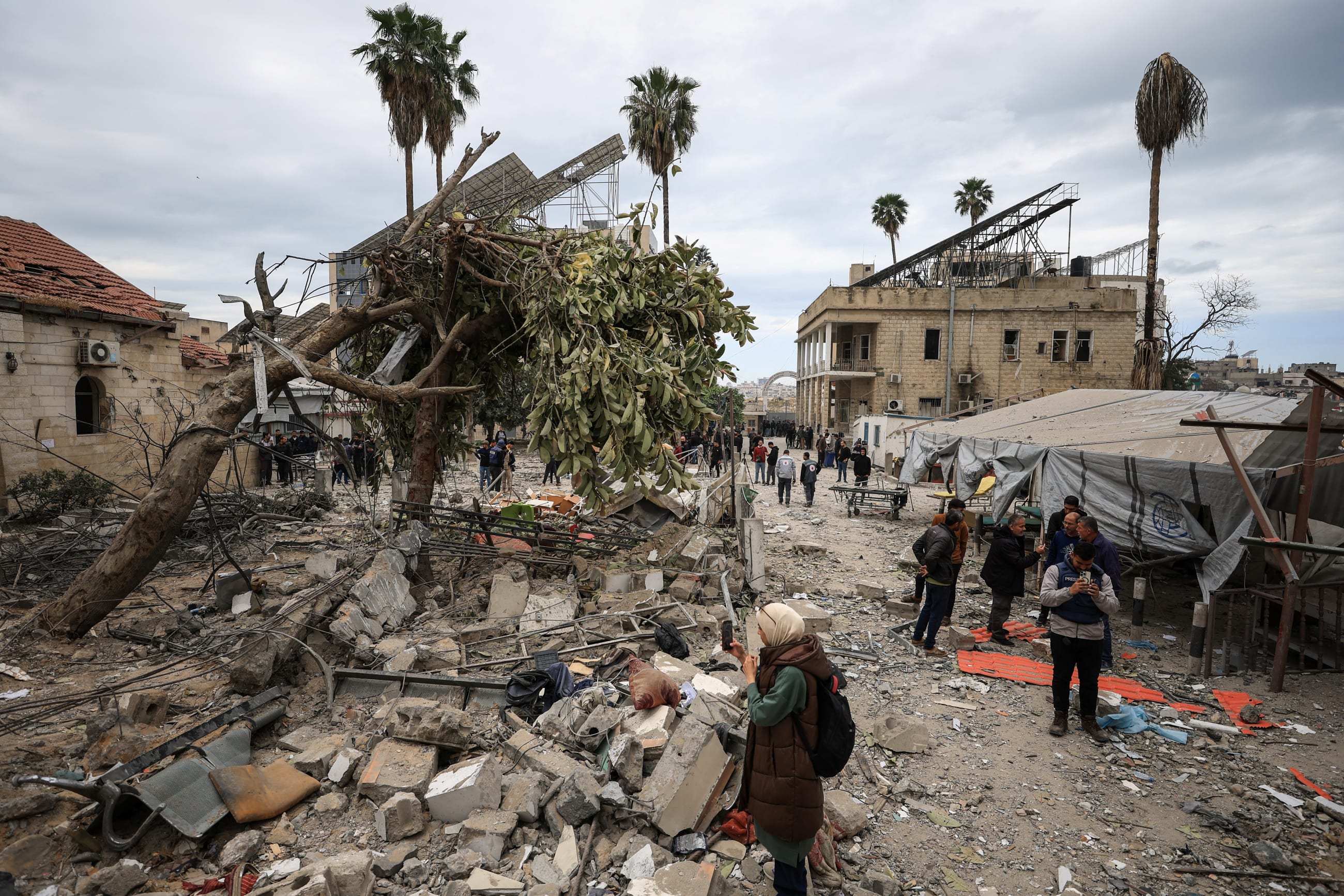 Palestinians inspect the damage after two Israeli missiles hit a building inside the Al-Ahli Arab Baptist Hospital, in the Gaza Strip, on April 13, 2025.