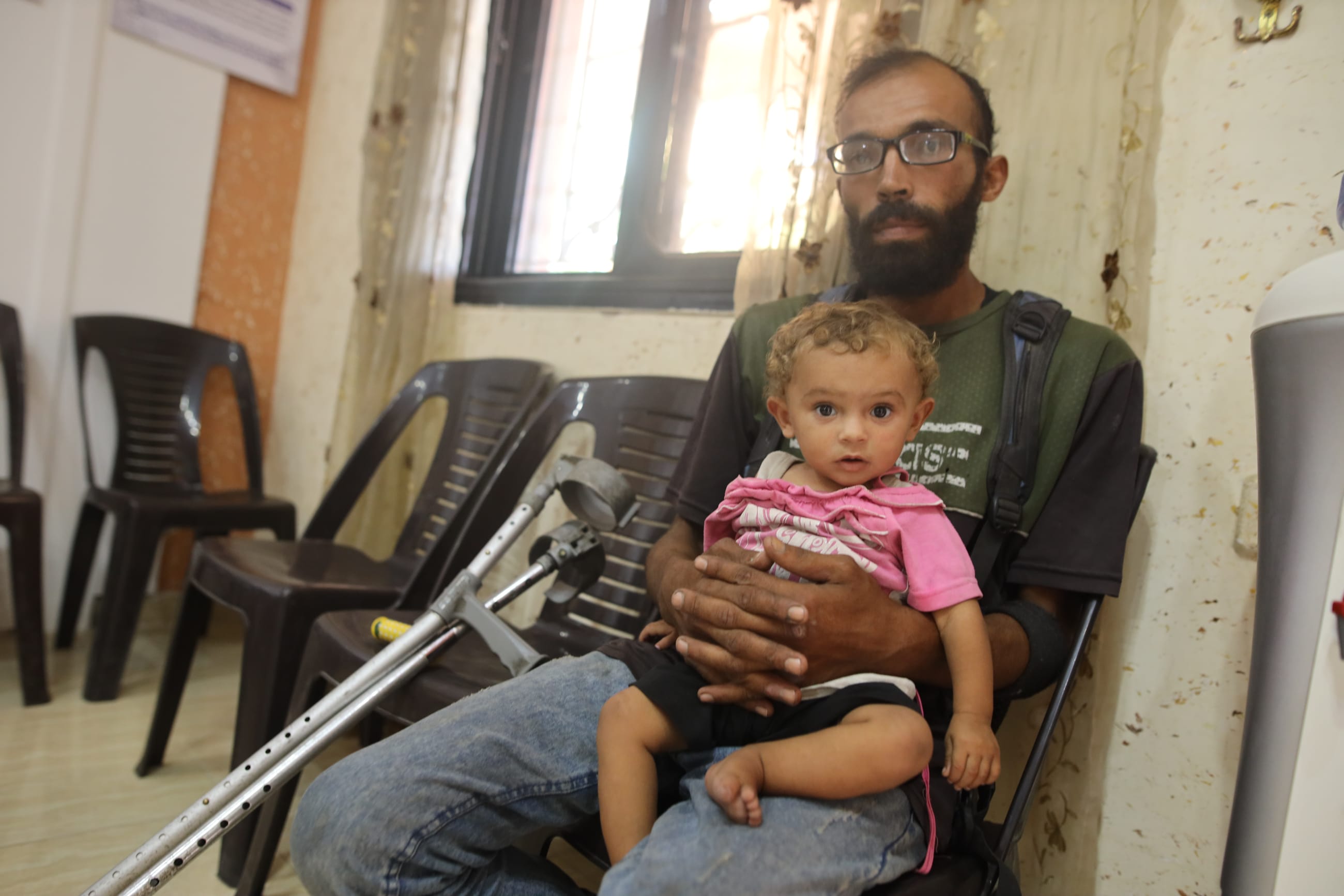 Hasan Zaghloul, 30, is an amputee and a widowed father of four who is displaced in Deir al-Balah. He is the sole caregiver for his children, including Sewar, who is one-and-a-half years old and undergoing treatment for malnutrition.