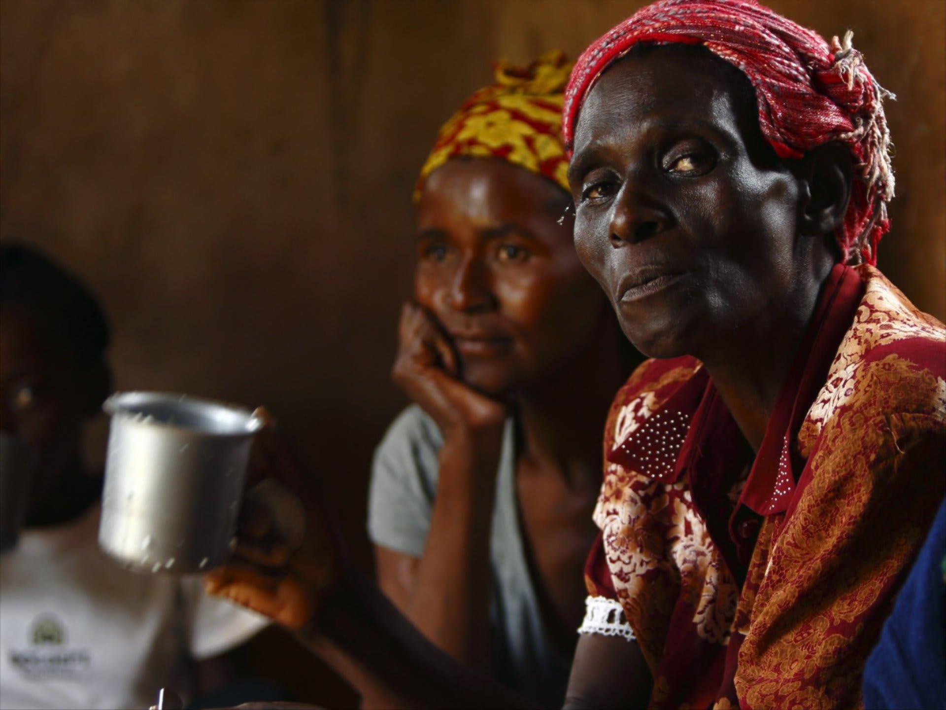 HIV-positive members of a self-help group meet with a caregiver in the village of Michelo, Zambia, on February 23, 2015. 