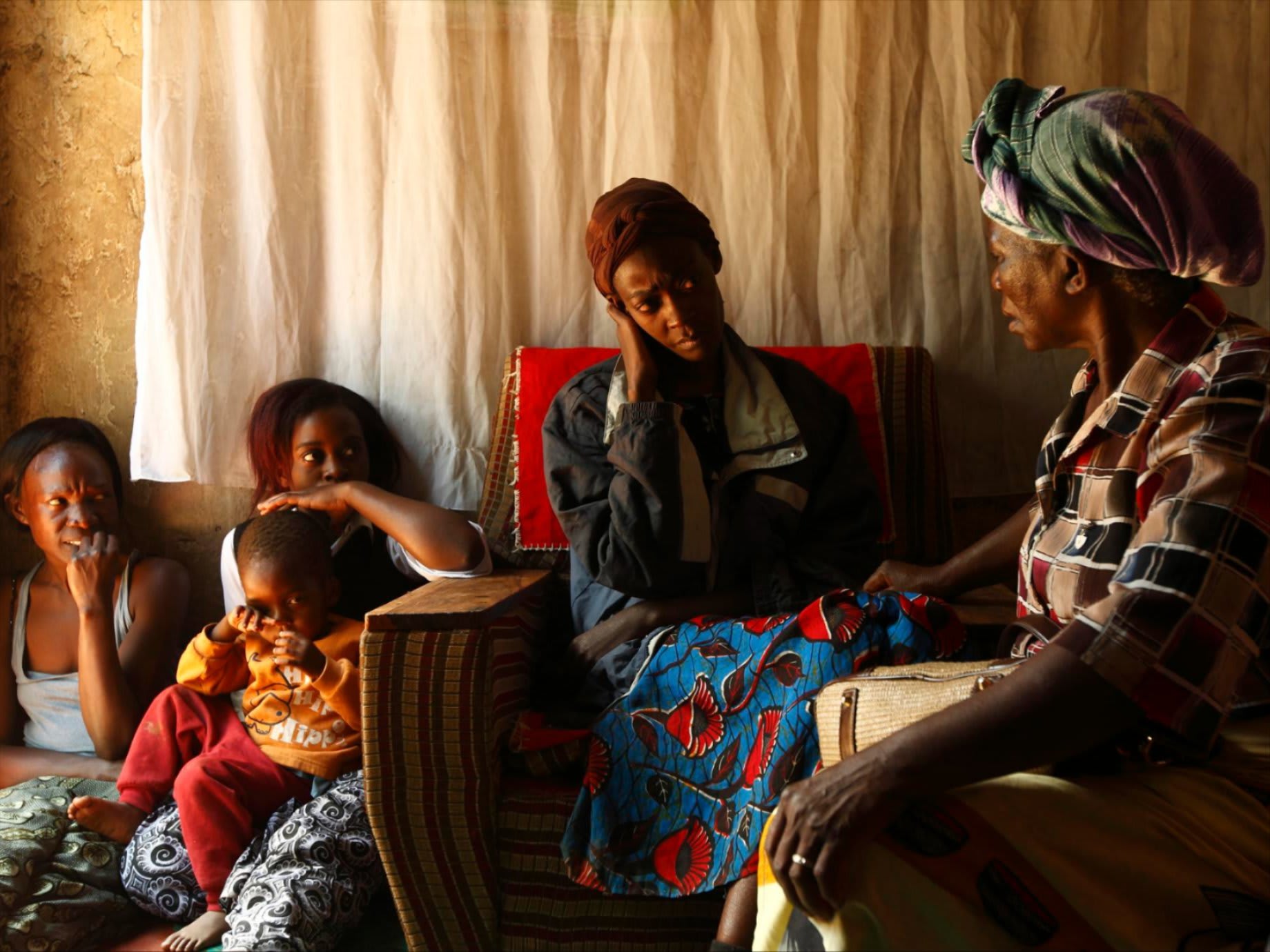 A home-based caregiver visits an HIV/AIDS patient in her home in Matero township, Lusaka, Zambia, on April 17, 2012.