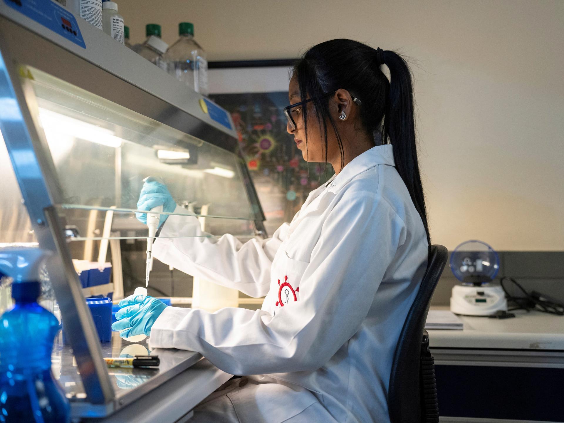 A medical laboratory technician at the Wits Antiviral Gene Therapy Research Unit, works in the research lab at the Wits University Faculty of Health Sciences, in Johannesburg, South Africa, on February 14, 2025. 