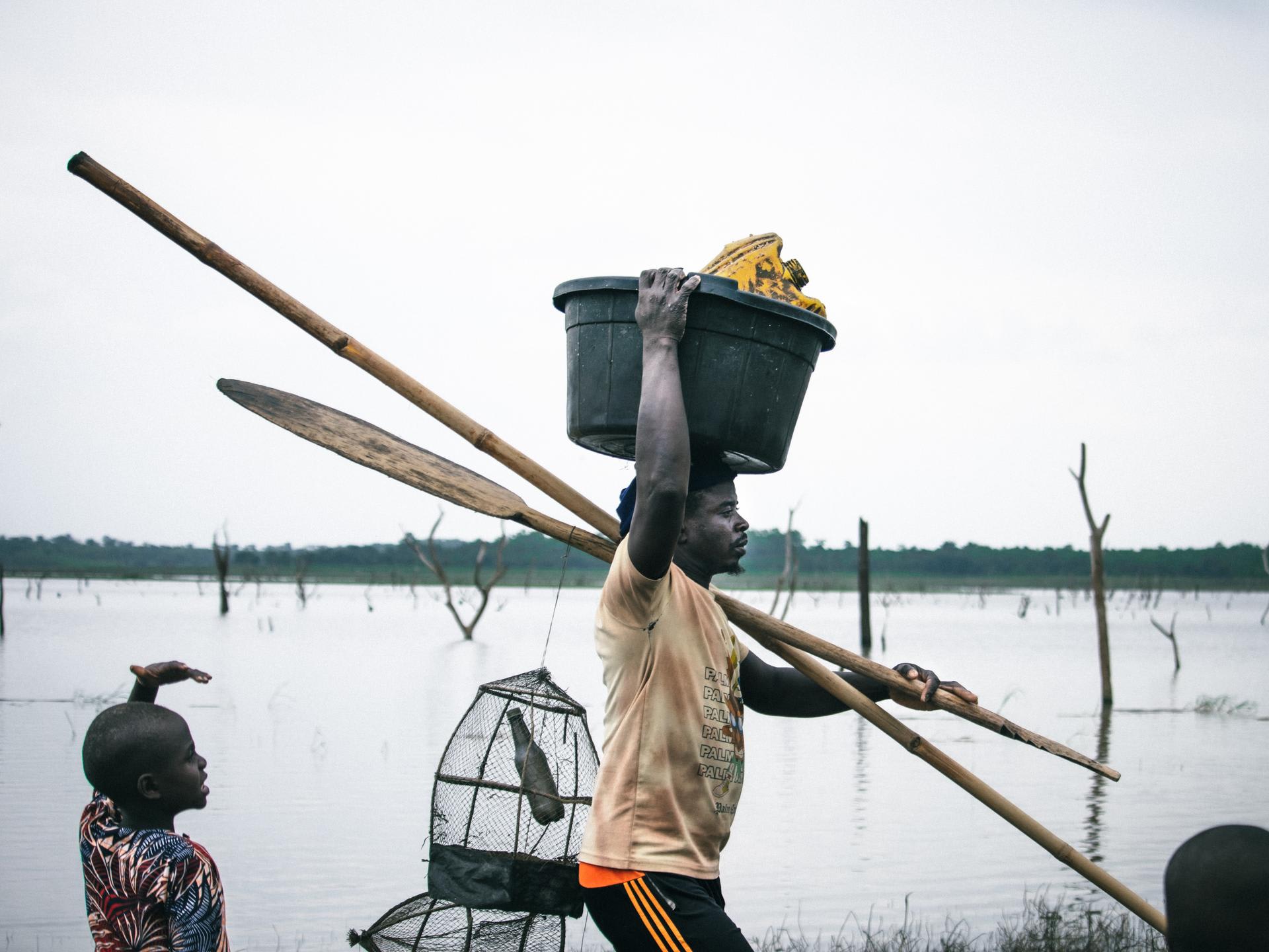 Fishermen are seen at the Oyan River, in Nigeria, on July 2025.