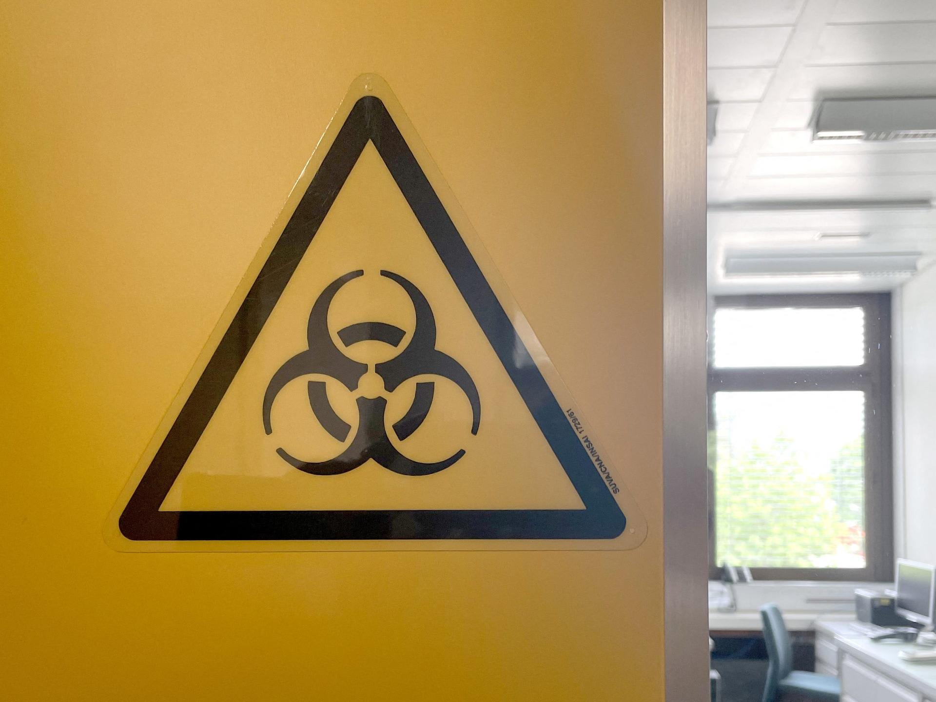 A biohazard sign is displayed in the biocontainment facility of the Spiez Laboratory, in Spiez, Switzerland, on June 8, 2022. 