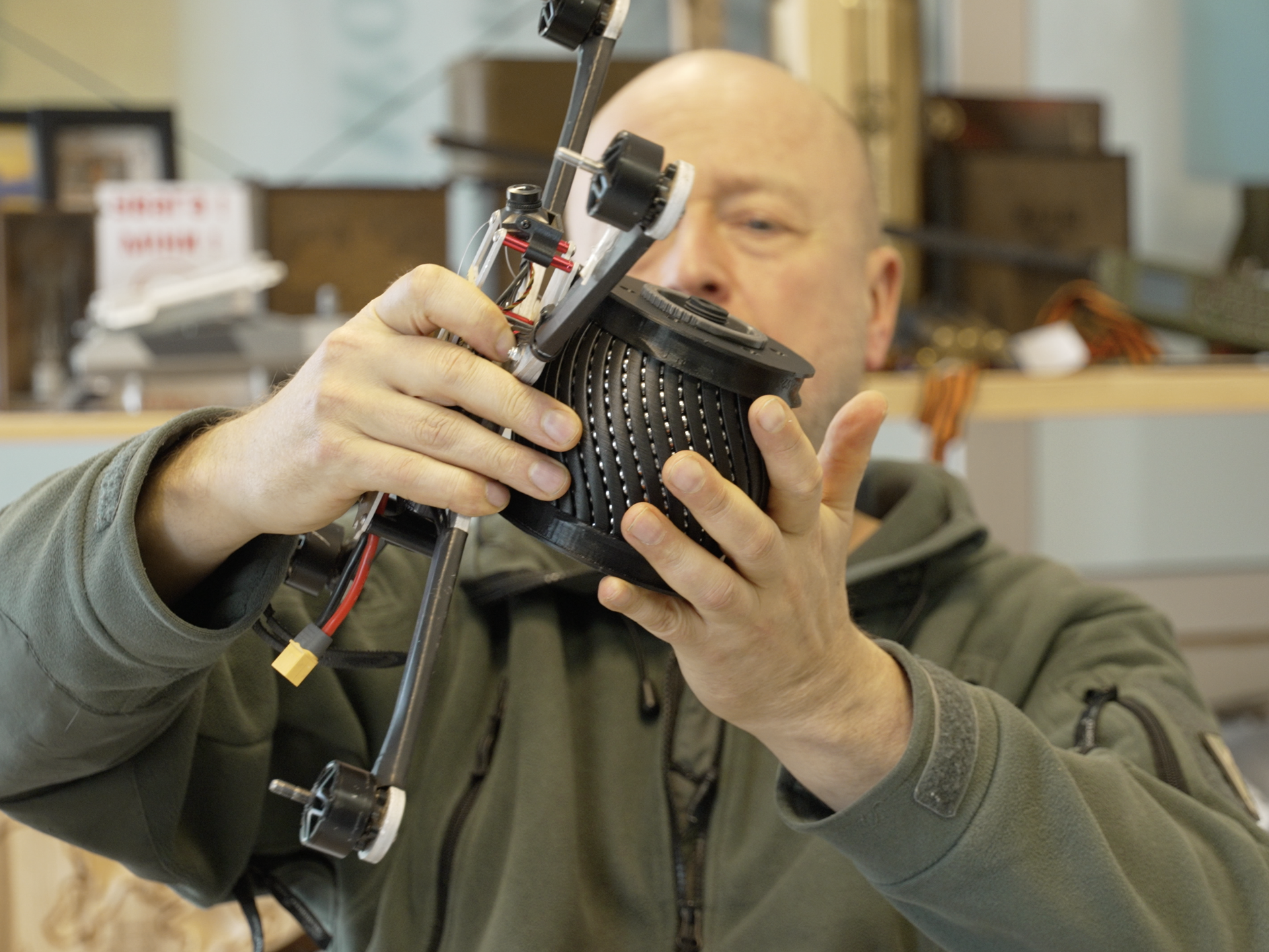 NGO Blue/Yellow co-founder Jonas Ohman puts an inert, drone-carried explosive on a drone at the NGO headquarters in Vilnius, Lithuania, in March 2026.