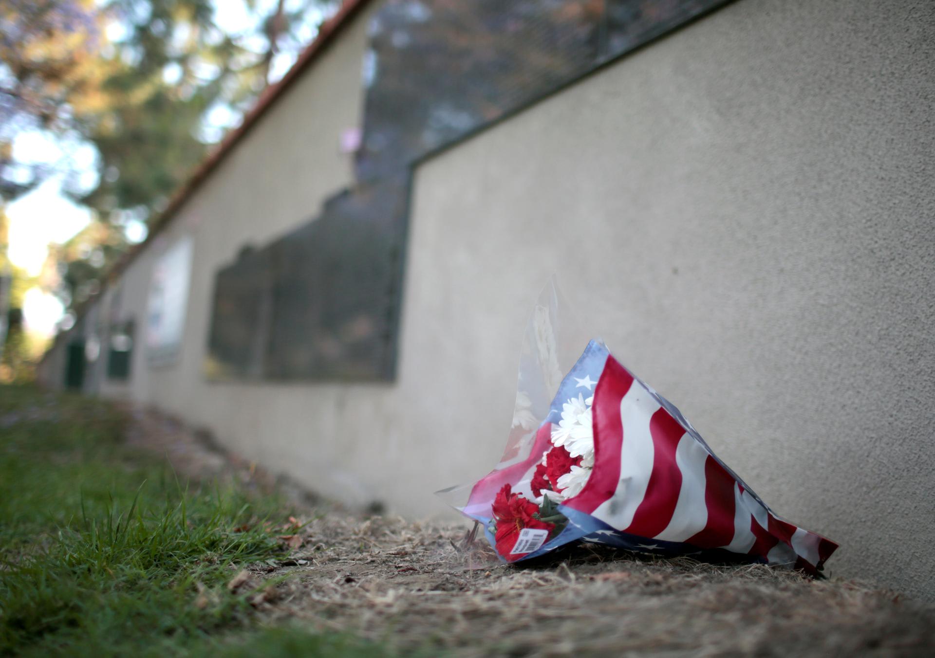 Flowers sit along the Rosie the Riveter Park Memorial Wall before a candlelight vigil for a veteran at a memorial wall for fallen veterans in Long Beach, California, U.S. May 29, 2017. 