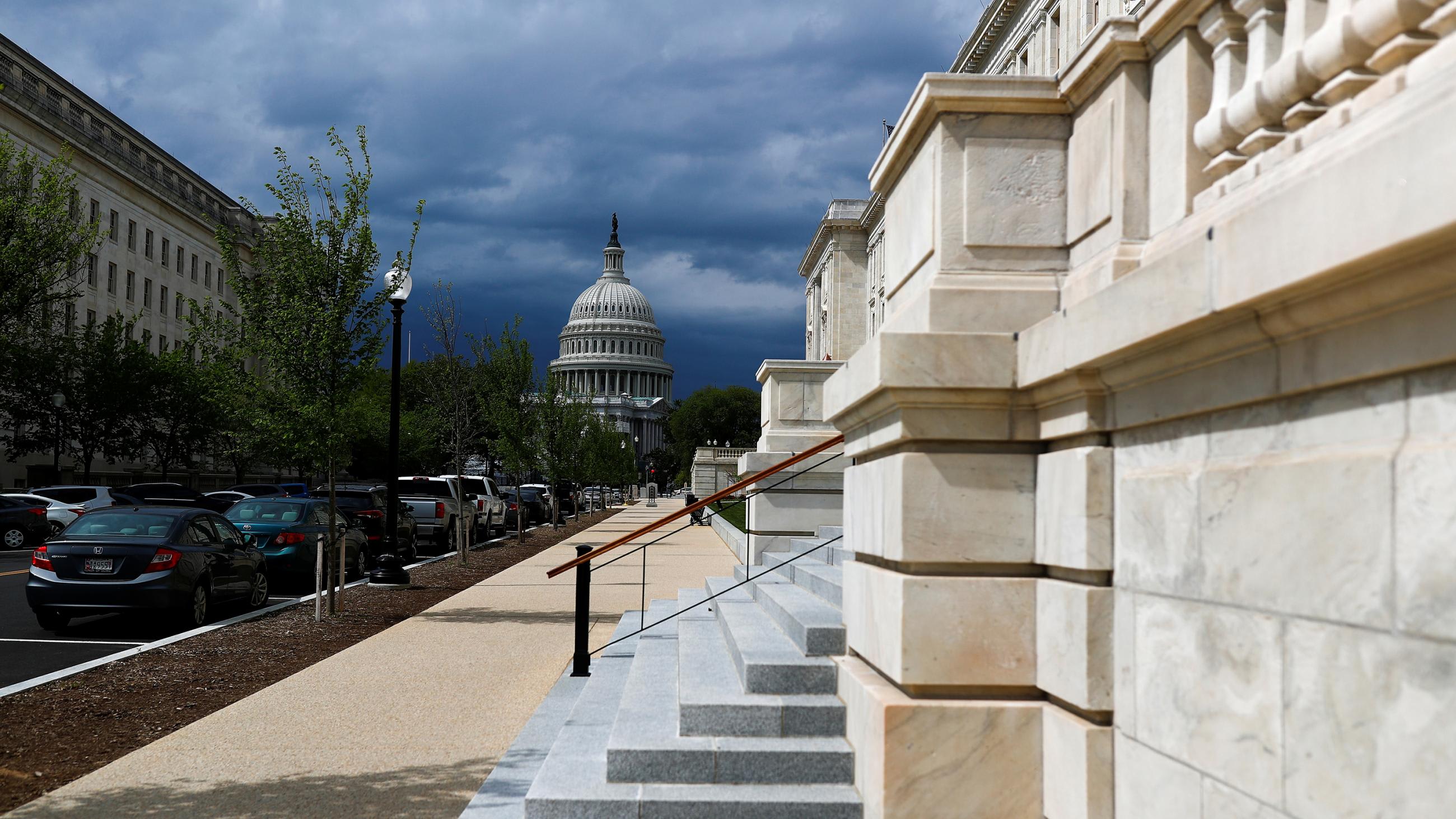 Picture shows the Capitol building from a distance with a set of stone steps in the foreground.