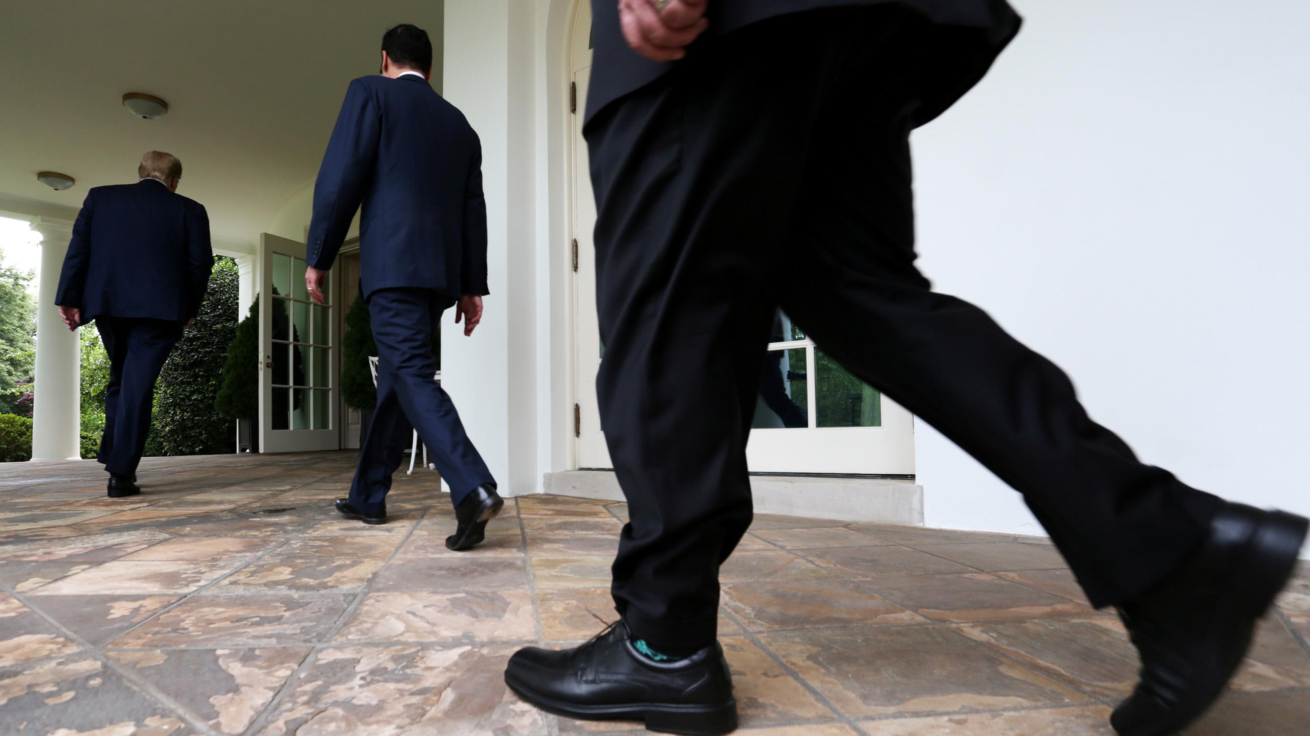 The photo shows the lower portion of the president walking past the camera with Treasury Secretary Steven Mnuchin and Secretary of State Mike Pompeo slightly ahead.