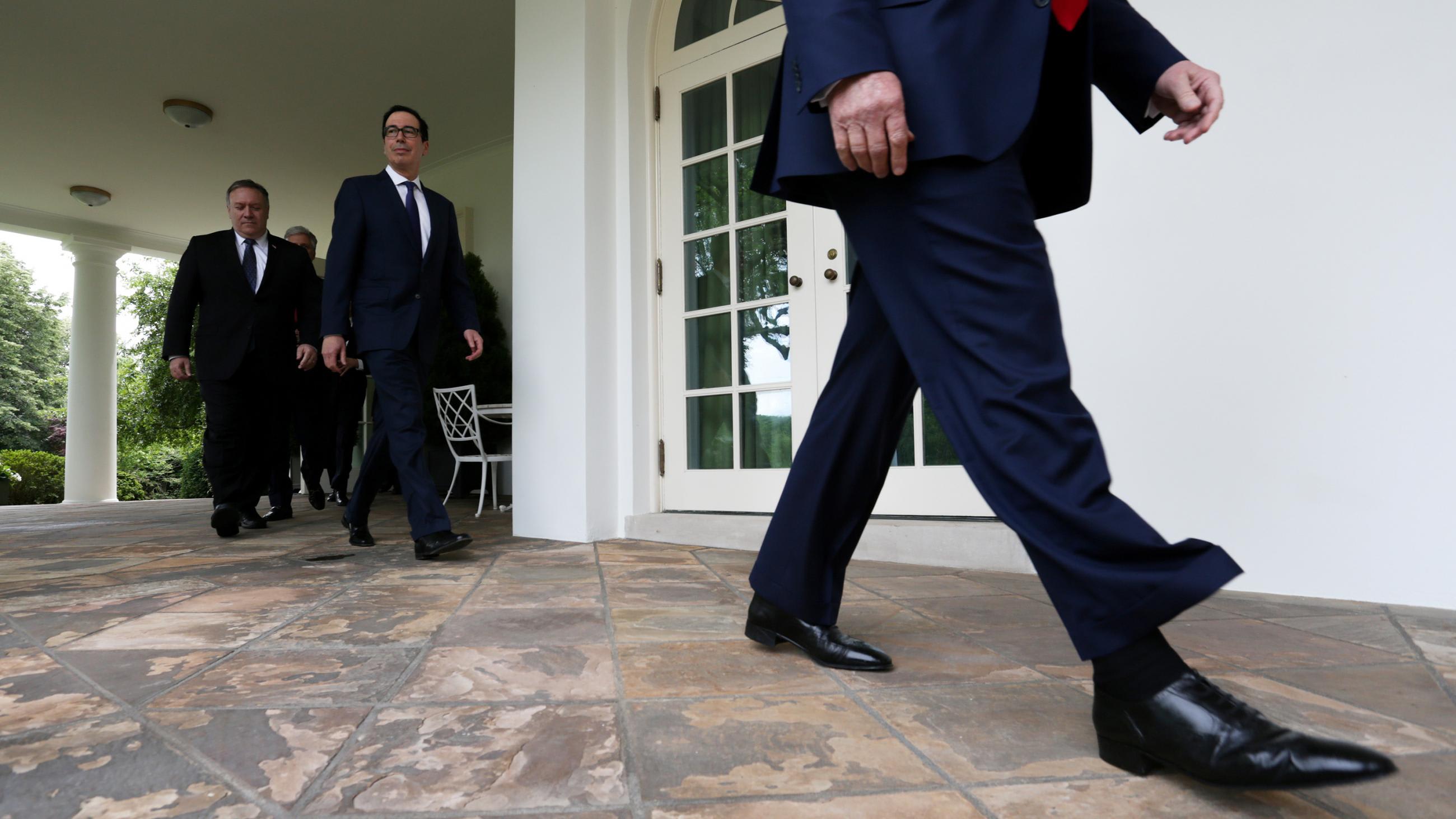 The photo shows the lower portion of the president walking past the camera with Treasury Secretary Steven Mnuchin and Secretary of State Mike Pompeo following close behind.