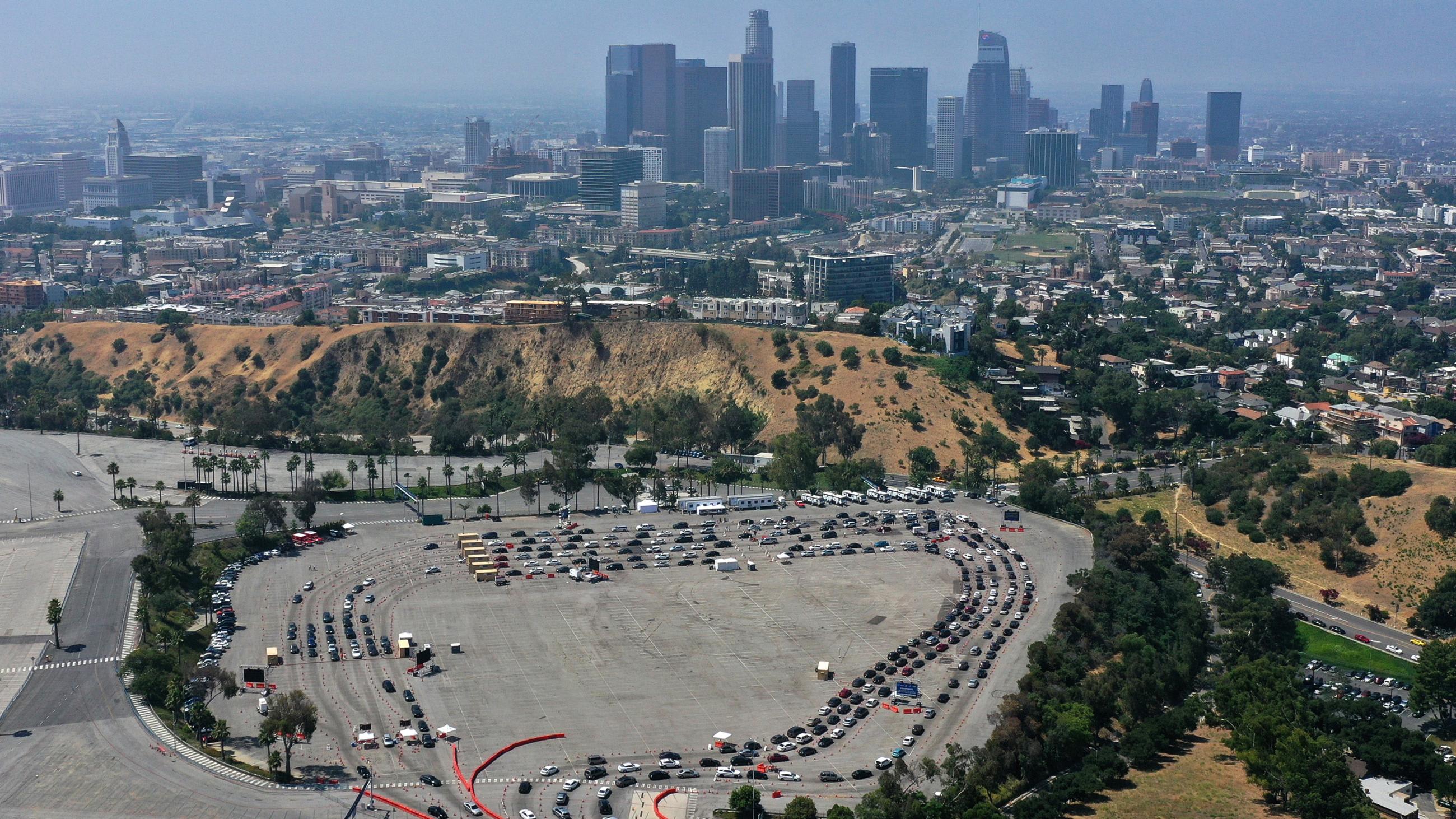 The photo is an aerial photo showing the sprawling stadium parking lot and lots of cars snaking through.