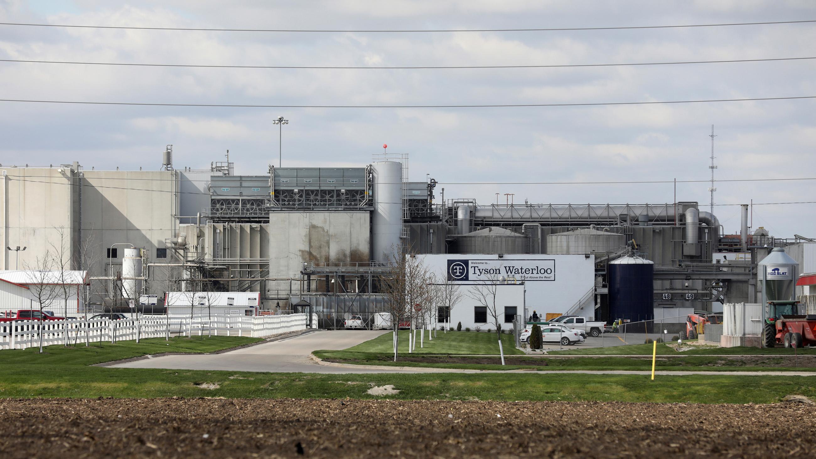 The photo shows the shuttered plant from behind a fence at a distance.