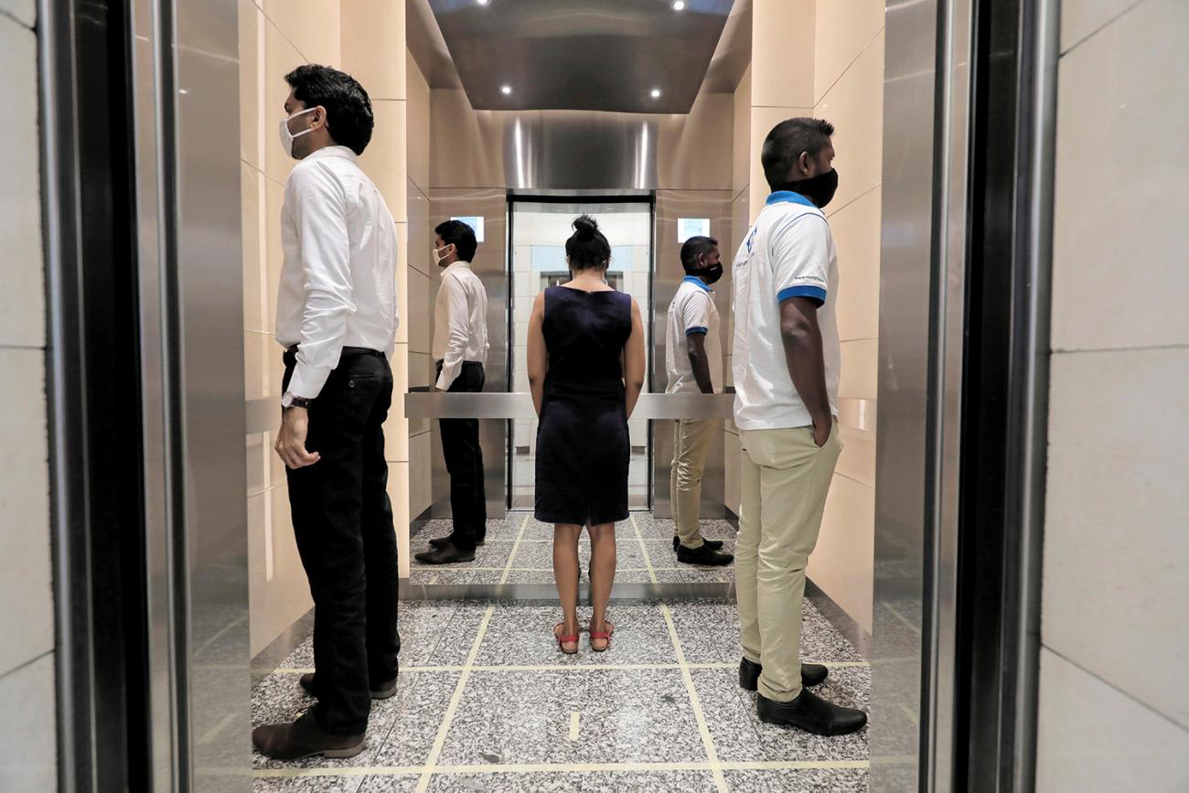 The photo shows an odd arrangement of businesspeople standing around and not facing one another.