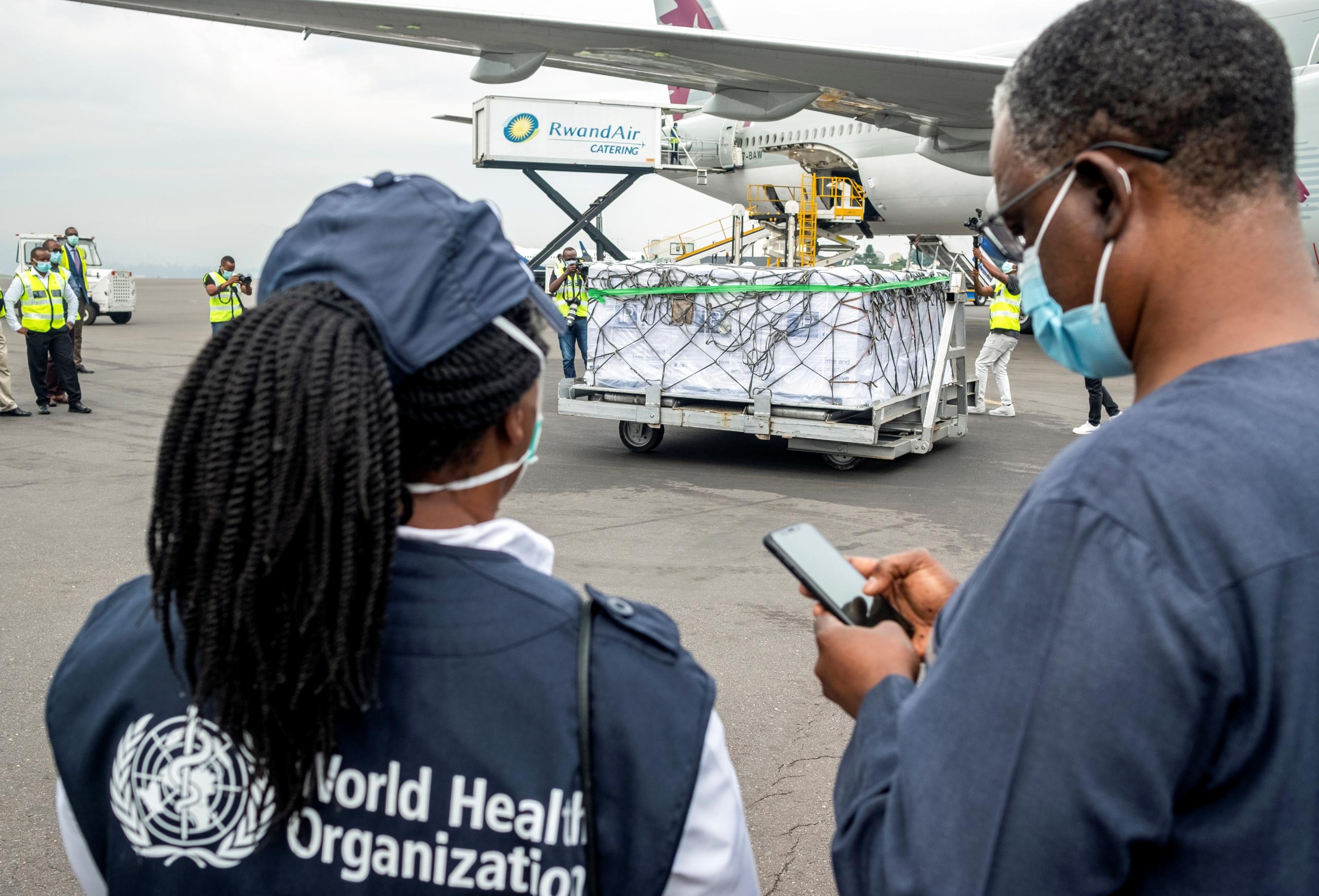 World Health Organization officials attend the arrival of the first batch of vaccines against the coronavirus disease at the Kigali International Airport in Kigali, Rwanda on March 3, 2021.