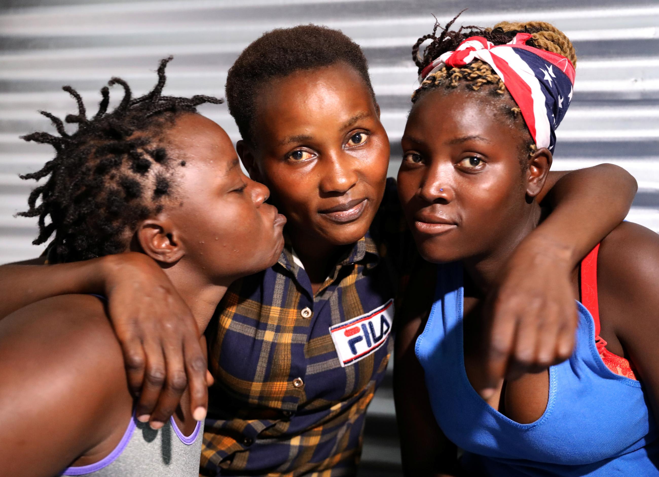 Ugandan refugees Ninshaba Erigalda, Shamim, and Nabaterega Winnie, members of the LGBTQI+ community, pose for a photo at the Kakuma refugee camp, in Turkana, Kenya, on February 22, 2020.