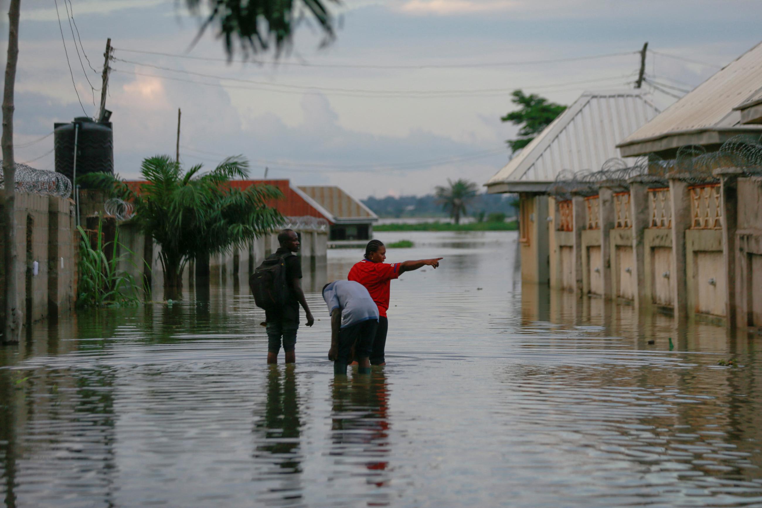 Victoria Okonkwo points at the direction of her flooded home close to the shore of River Benue in Makurdi, Nigeria, September 30, 2022.