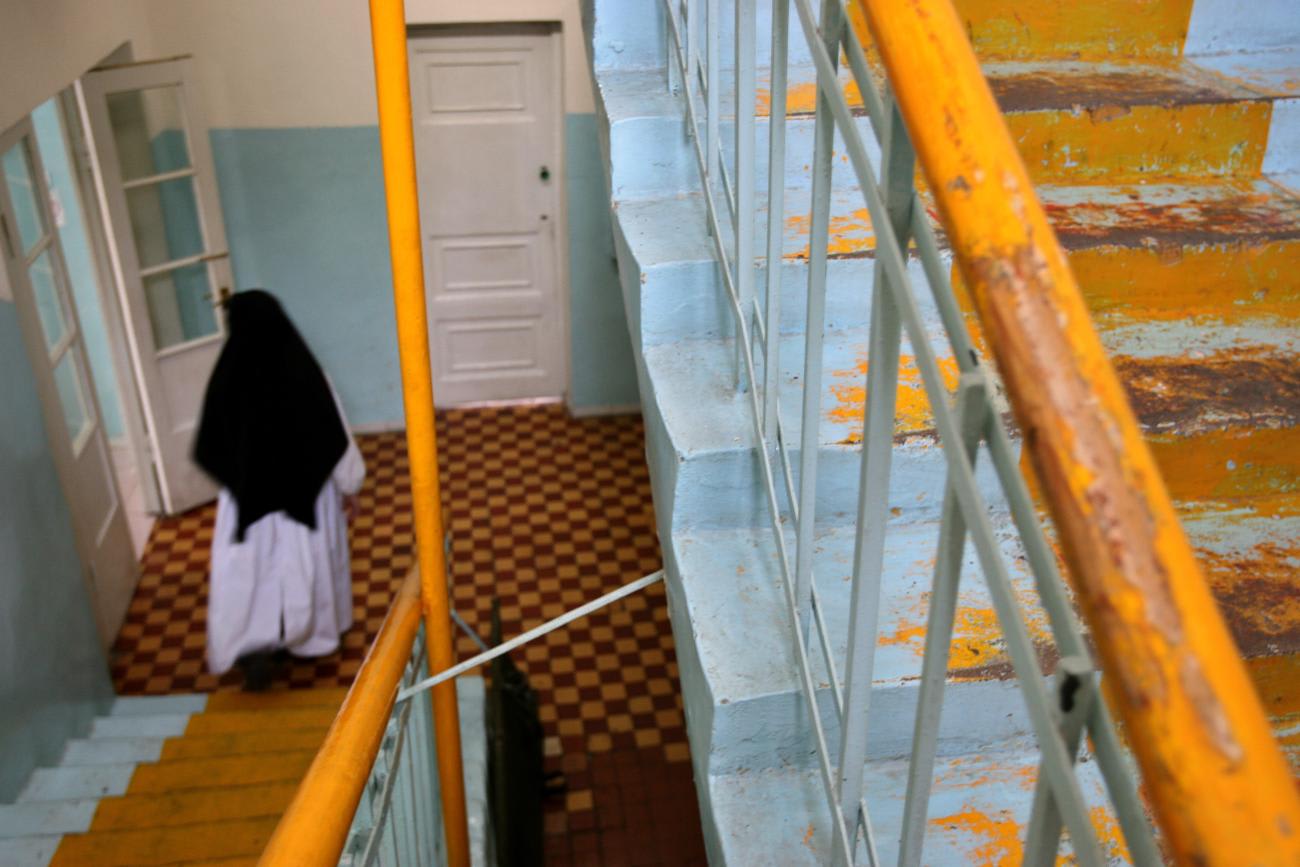 Doctor Sister Marie Benedict walks down the stairs at a hospital supported by her and other nuns of Fraternite Notre Dame in the Mongolian capital of Ulan Bator, on January 19, 2006.