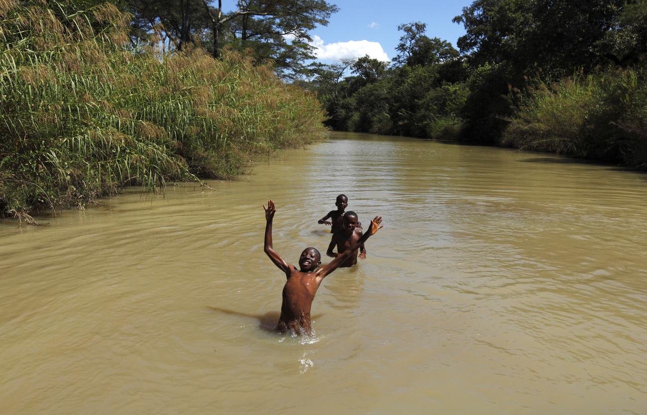 Children swim in a river close to the town of Chikuni in the south of Zambia on April 18, 2012.