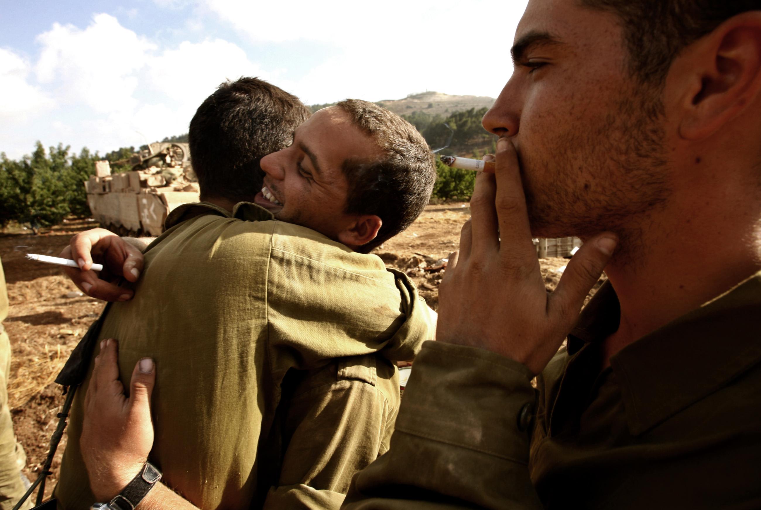 Israeli soldiers embrace near the northern Israeli town of Menara on the Israel-Lebanon border, after returning from combat operations in southern Lebanon, August 14, 2006.