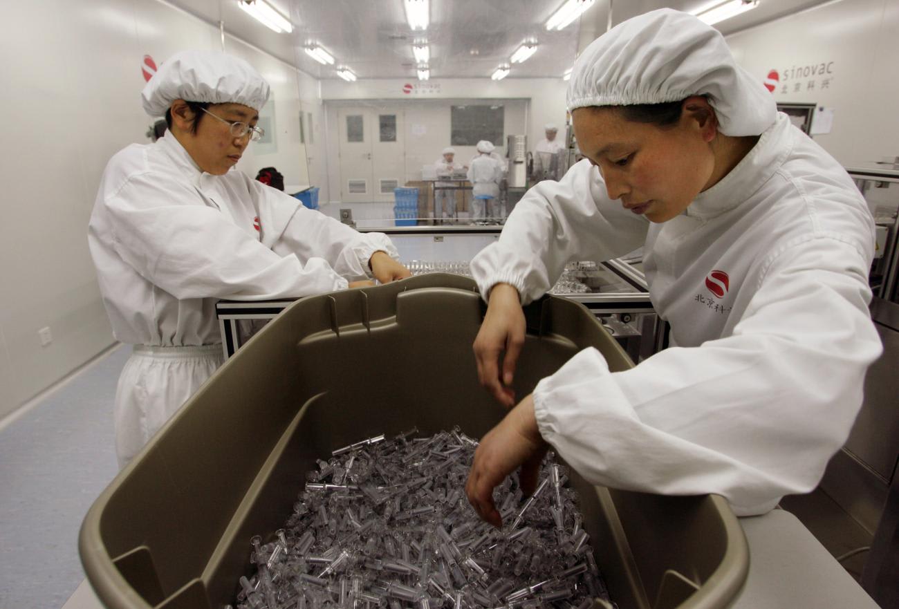 Workers arrange vaccines at Sinovac Biotech Co. Ltd.'s headquarters in Beijing.