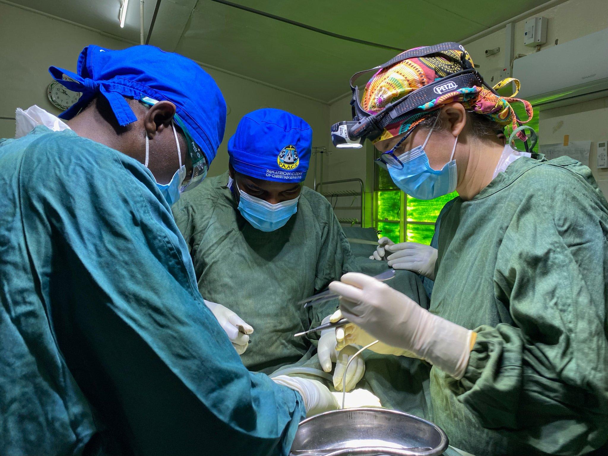 Dr. Stuebing is faculty for the PAACS (Pan African Academy of Christian Surgeons) training program at Nkhoma Mission Hospital in Malawi. Here she is operating with two of her residents, Dr Kapengule and Dr Mwafulirwa. They are removing a sigmoid colon for volvulus (twisting of the sigmoid colon).