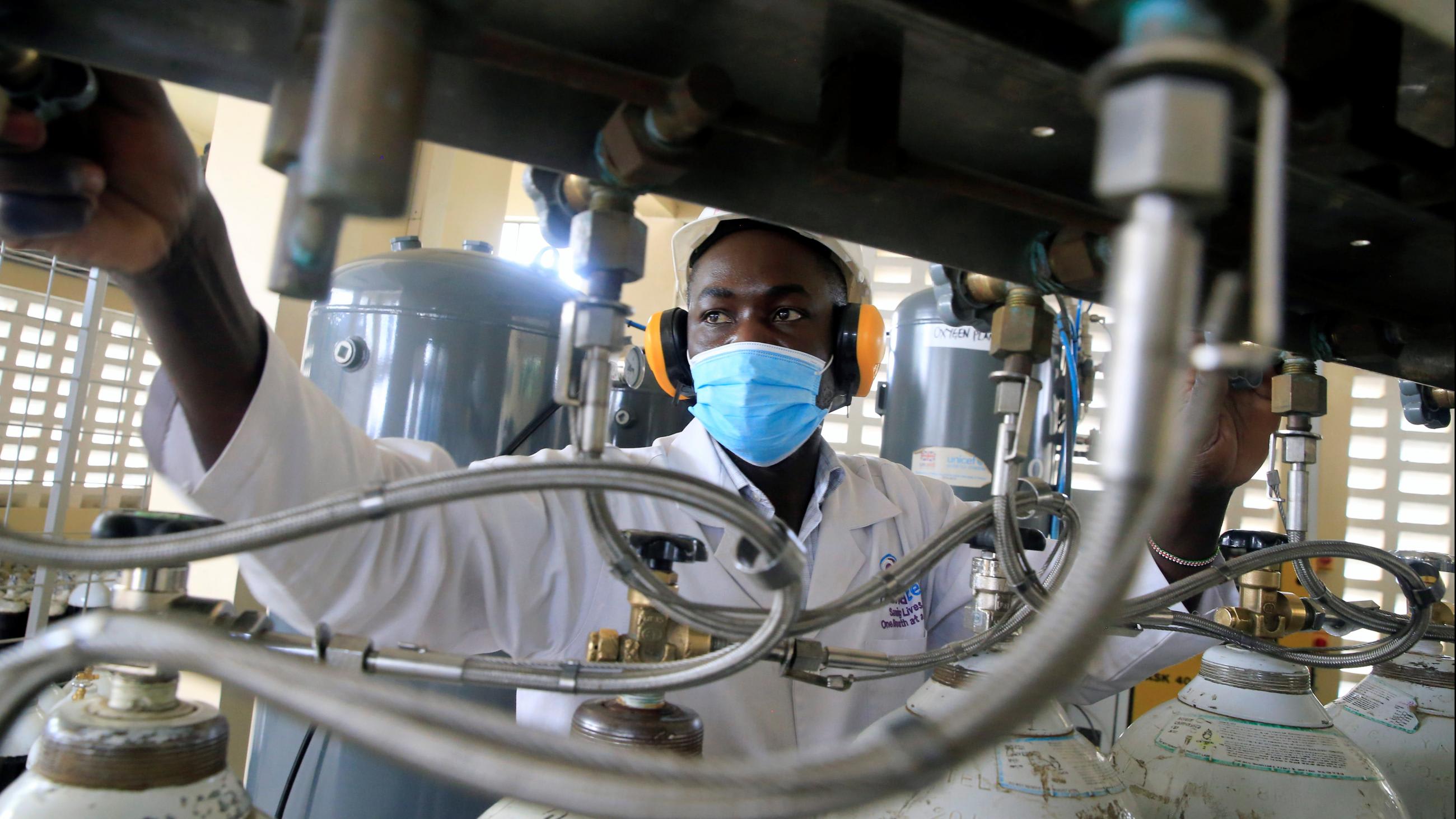 Bernard Olayo, the founder of Hewatele, an innovative oxygen supply company, checks oxygen cylinders ahead of delivery to health facilities in Nairobi, Kenya, on August 3, 2021.