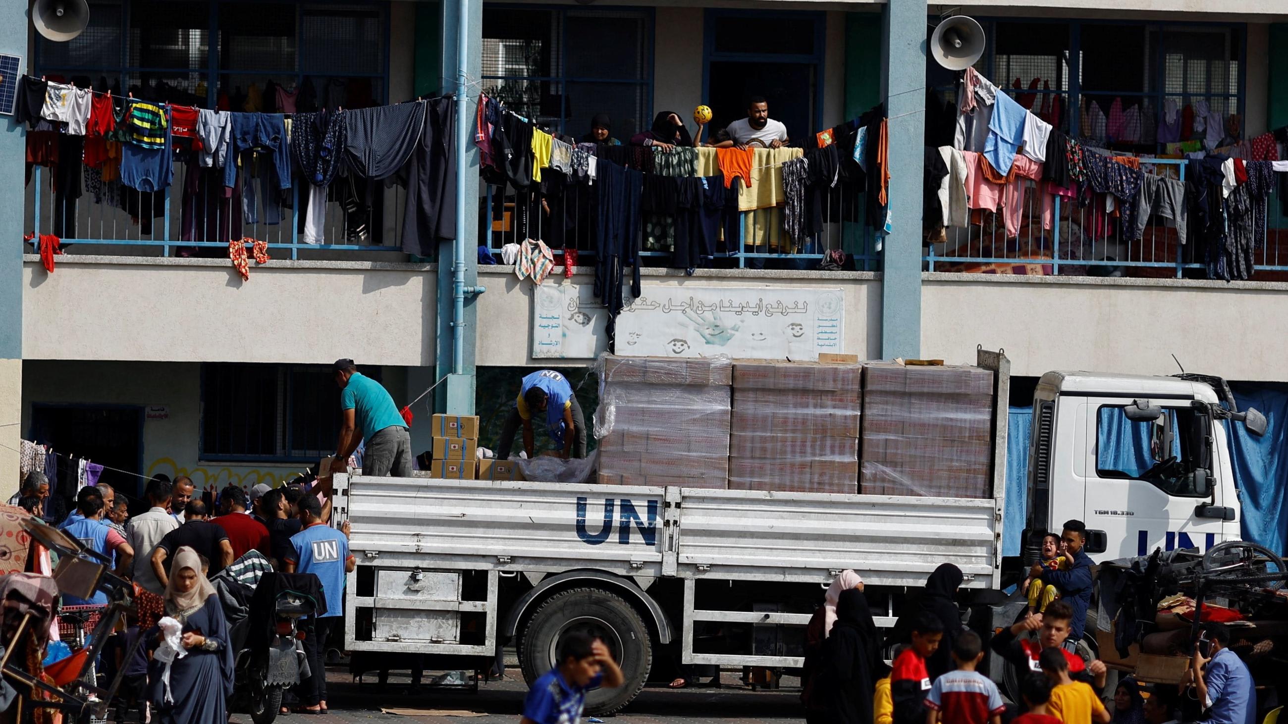 A UN aid truck is seen distributing aid to Palestinians