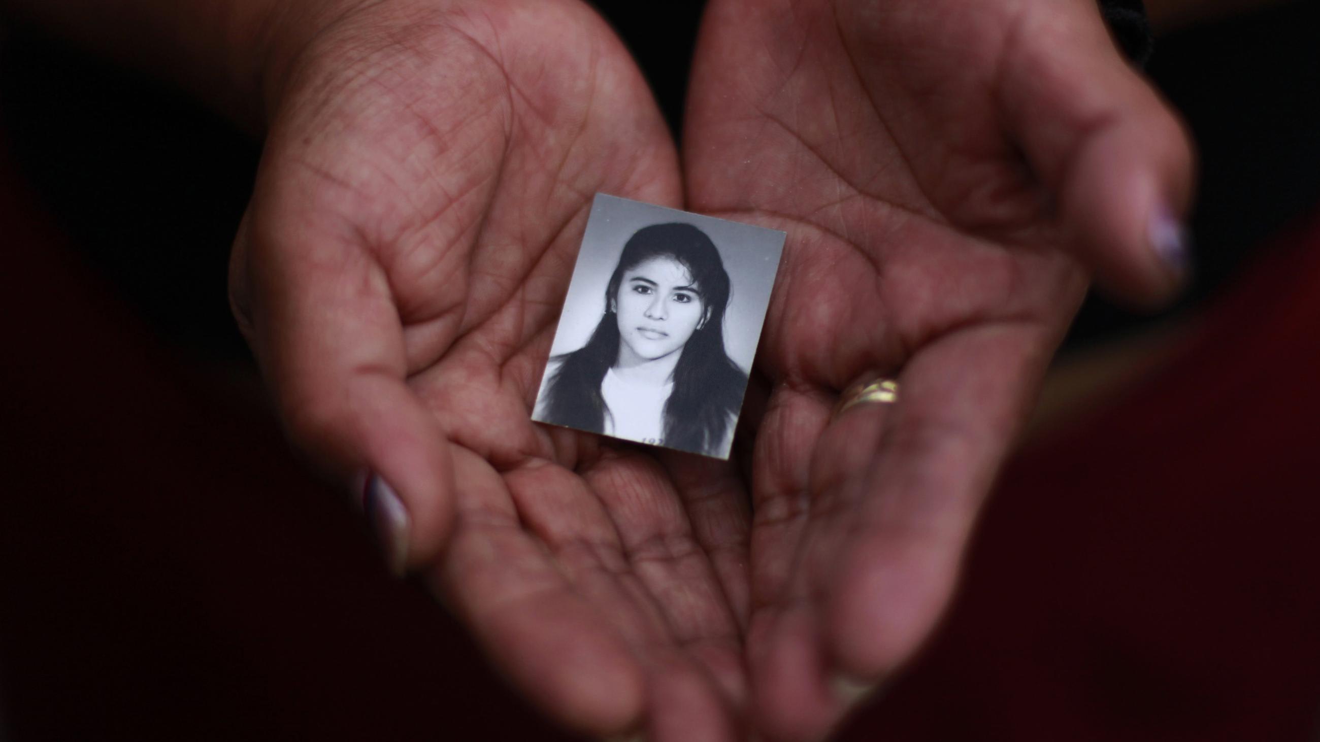 A family member holds a photograph of Rosivel Elisabeth Grande in Quezaltepeque, Honduras, on July 2, 2013. Grande was killed by an unidentified man who shot her five times when she was going to work