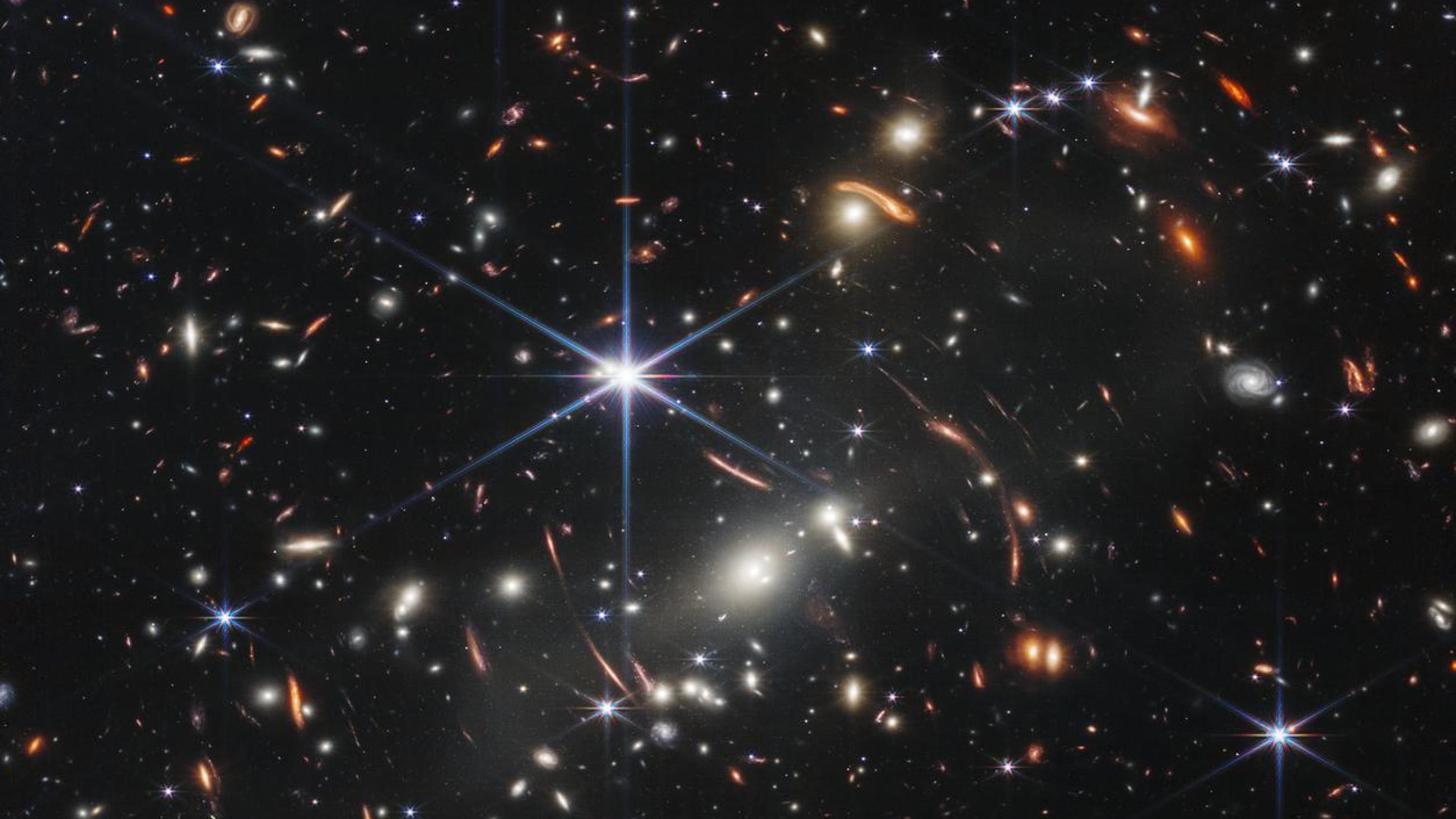 Thousands of galaxies flood this near-infrared image of galaxy cluster SMACS 0723. High-resolution imaging from NASA’s James Webb Space Telescope combined with a natural effect known as gravitational lensing made this finely detailed image possible.