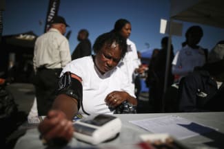 Bernita Jackson, 51, has her blood pressure measured at an event to inform people about the Affordable Care Act, in Los Angeles, California, on November 25, 2013.