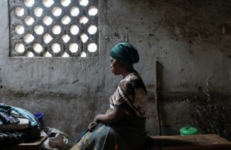 Florence Mushimye poses for a portrait in a classroom where they are taking refuge after being asked to leave Kalenga village by the M23 rebels, in Sake, eastern Democratic Republic of Congo, on March 13, 2025.