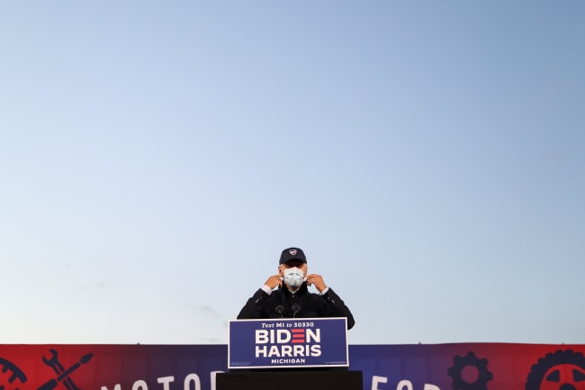 U.S. President-elect Joseph R. Biden prepares to remove his face mask to deliver remarks during a voter mobilization event at the Michigan State Fairgrounds in Novi, Michigan on October 16, 2020. 
