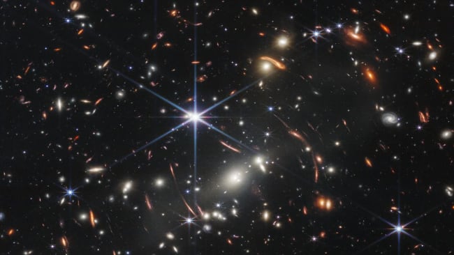 Thousands of galaxies flood this near-infrared image of galaxy cluster SMACS 0723. High-resolution imaging from NASA’s James Webb Space Telescope combined with a natural effect known as gravitational lensing made this finely detailed image possible.