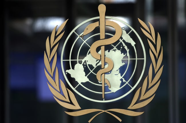 A logo is pictured on the headquarters of the World Health Organization (WHO) ahead of a meeting of the Emergency Committee on the novel coronavirus in Geneva, Switzerland on January 30, 2020. The photo shows a closeup of the logo on a dark background. REUTERS/Denis Balibouse