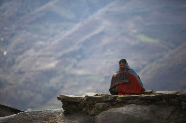 Surja Devi Saud practices Chaupadi outside her house, in Achham District, Nepal, on February 16, 2014. Chaupadi is a tradition observed in parts of Nepal, where women sleep outside while menstruating.