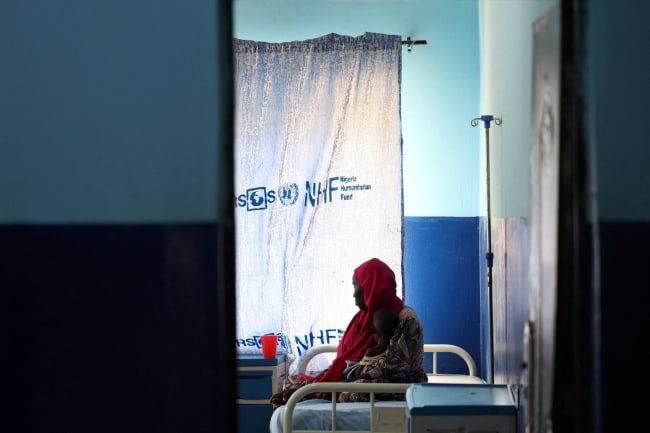 A woman and her child, who is suffering from malnourishment, wait for care at Dikwa Primary Health Center's emergency ward, following the withdrawal of USAID support, in Dikwa, Borno State, Nigeria, on August 27, 2025.