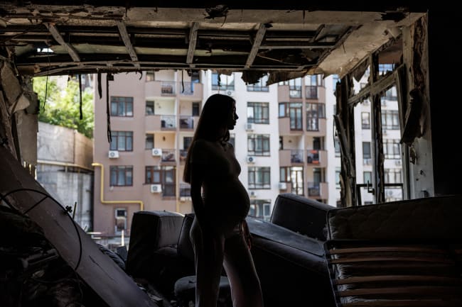 Bohdana Zhupanyna, a 30-year-old mother-to-be, stands inside her apartment that was damaged by a Russian drone strike, amid Russia's attack, in Kyiv, Ukraine, on July 23, 2025.